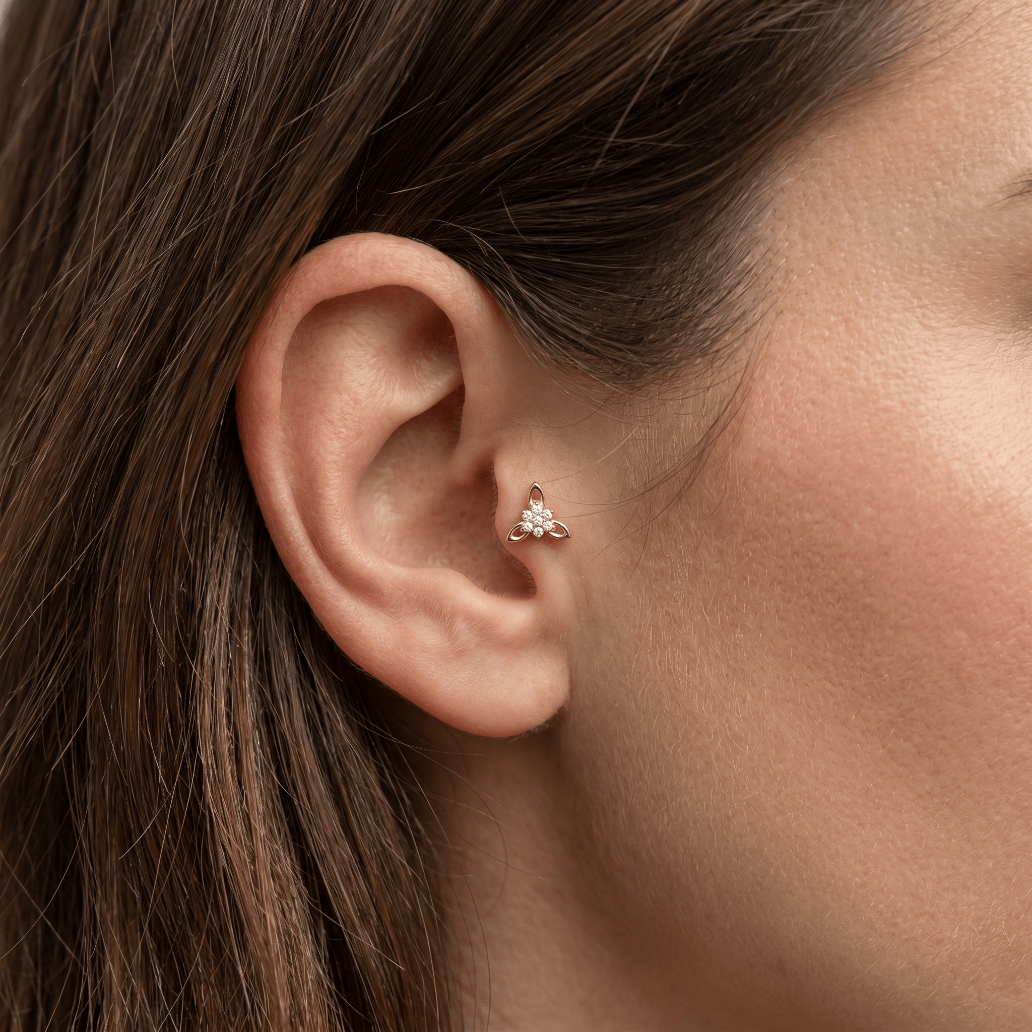 Gold titanium CZ flower cluster piercing stud worn perfectly in a female