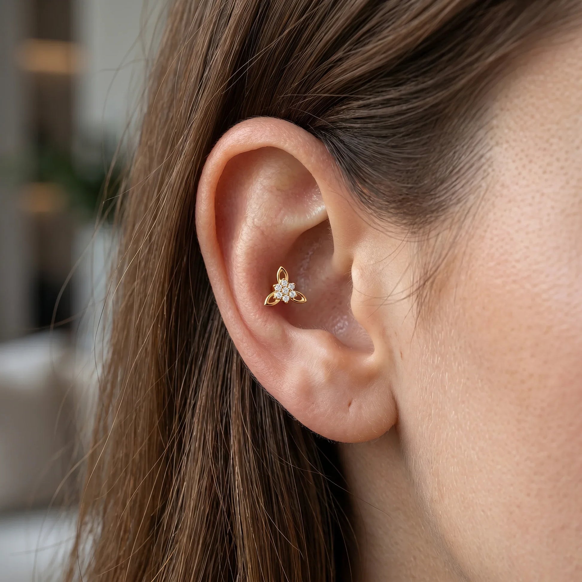 Gold titanium CZ flower cluster piercing stud worn beautifully in a female