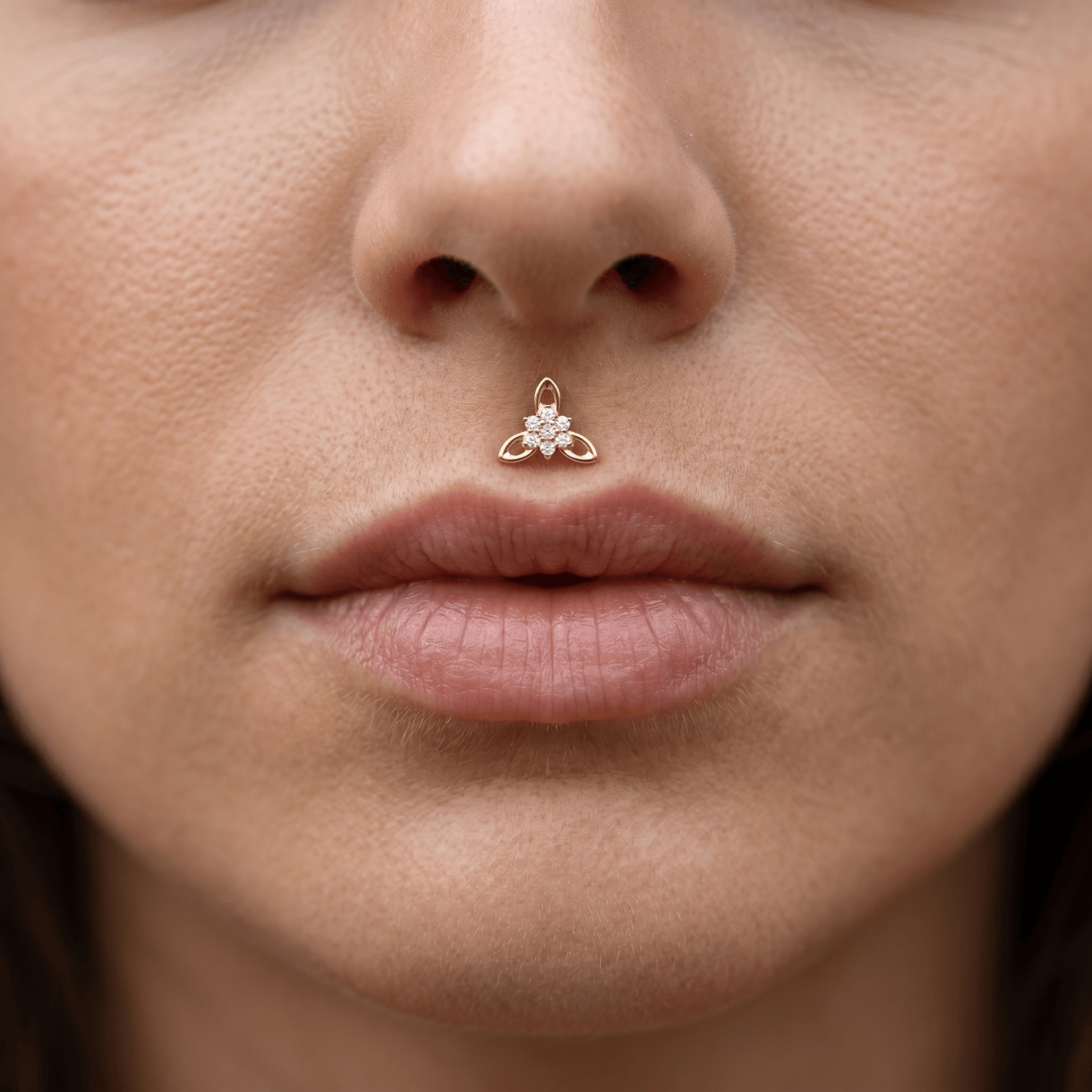 Gold titanium CZ flower cluster piercing stud worn elegantly in a female