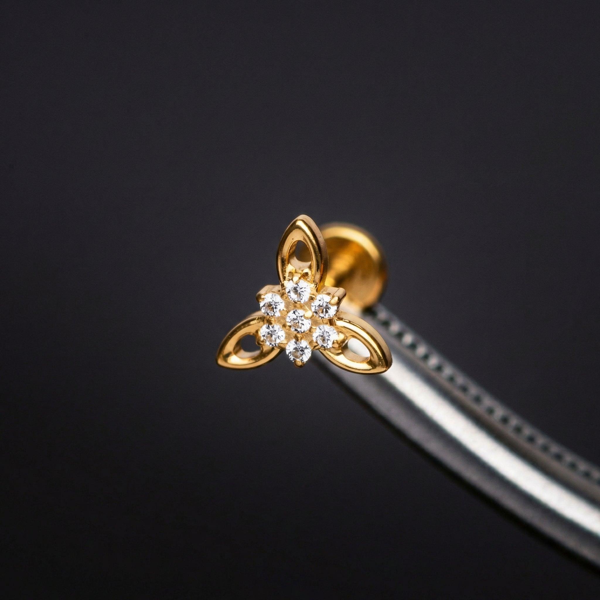 Cz Front Helix Piercing - Tweezers holding a gold