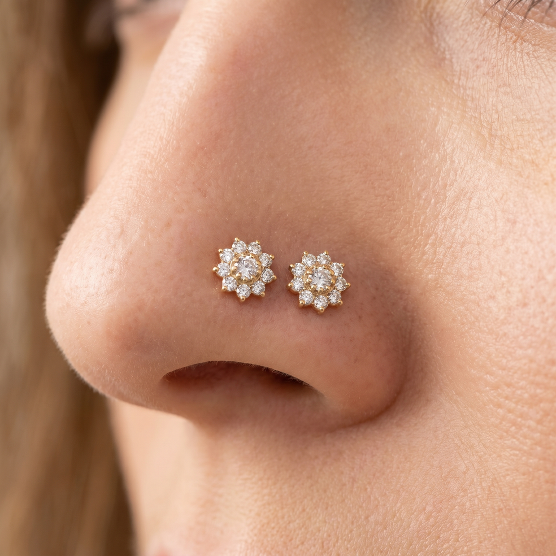 Two flower nose studs styled as a double nose piercing on one nostril