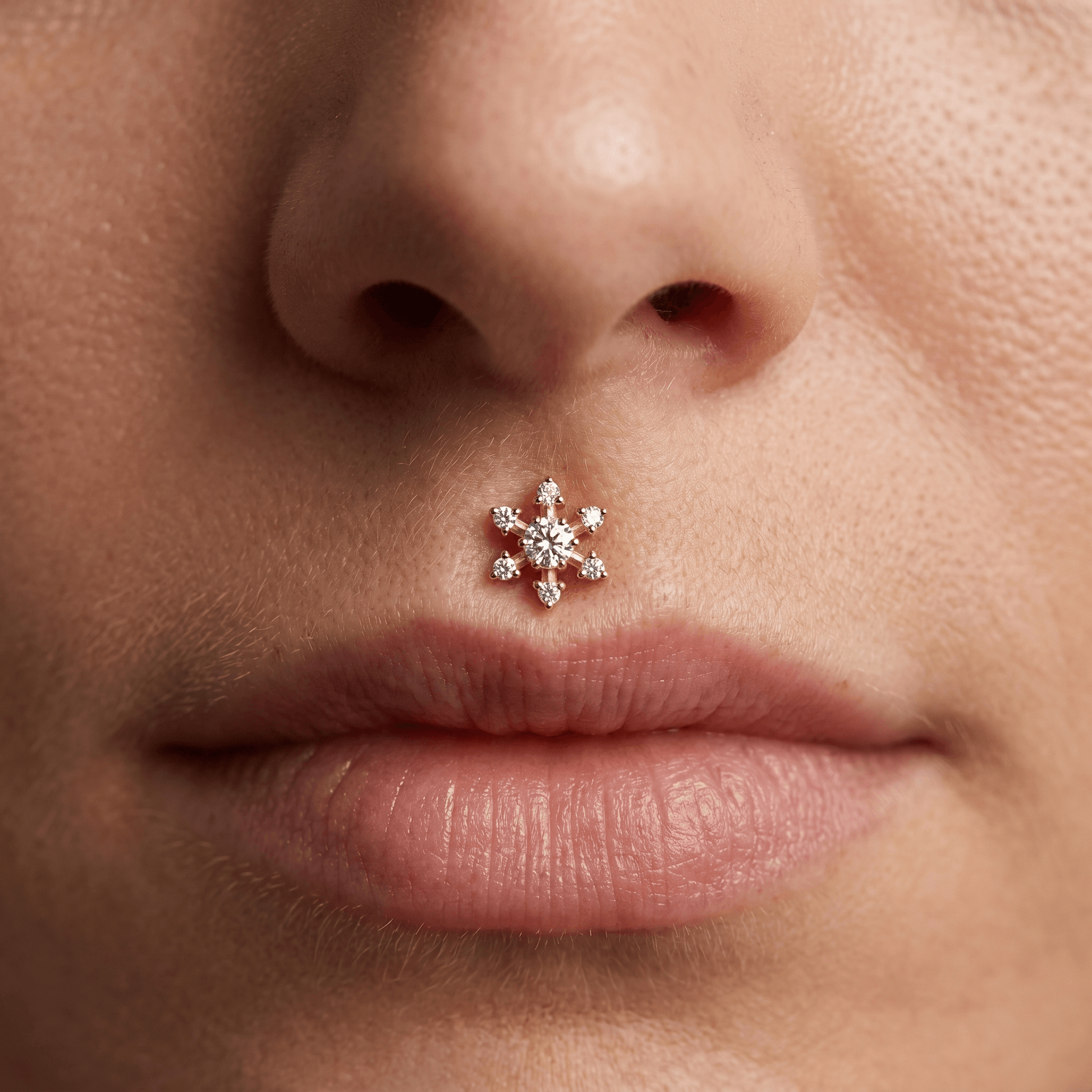 Gold flower zircon stud — piercing placement