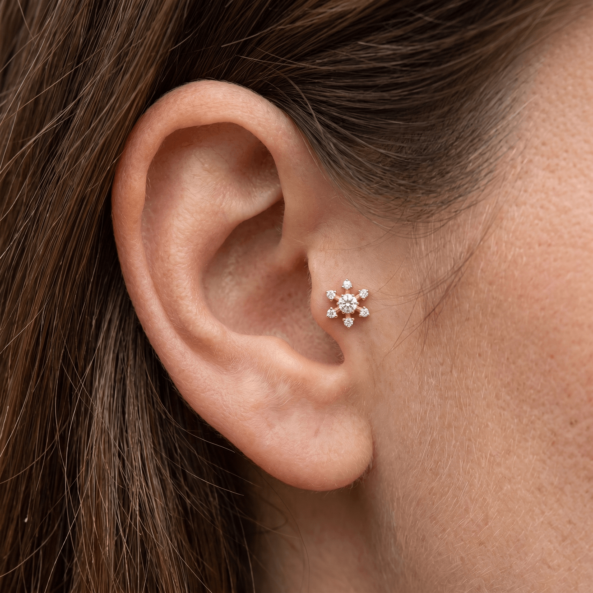 Gold flower piercing stud worn elegantly in a placement.