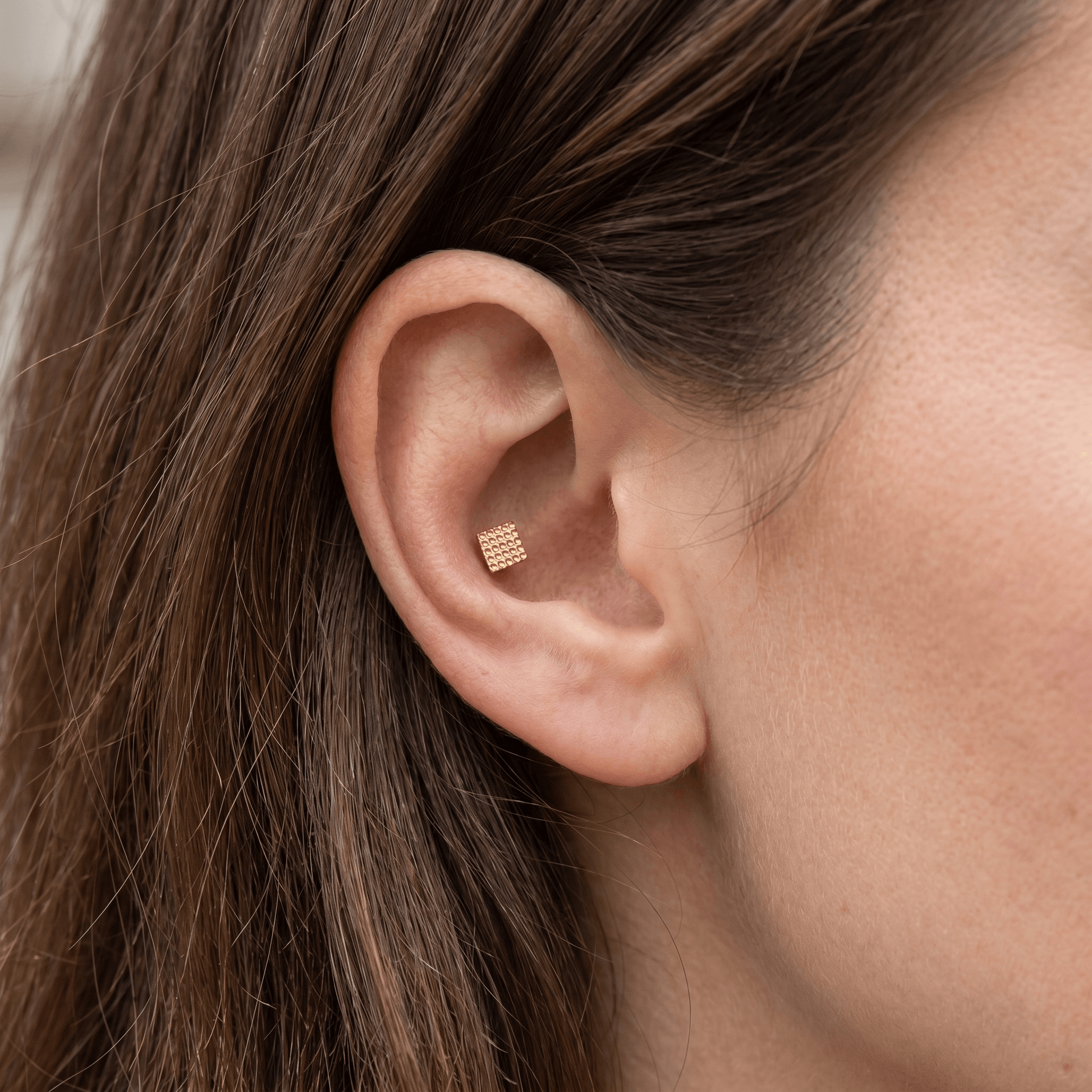 Gold titanium styled in an piercing.