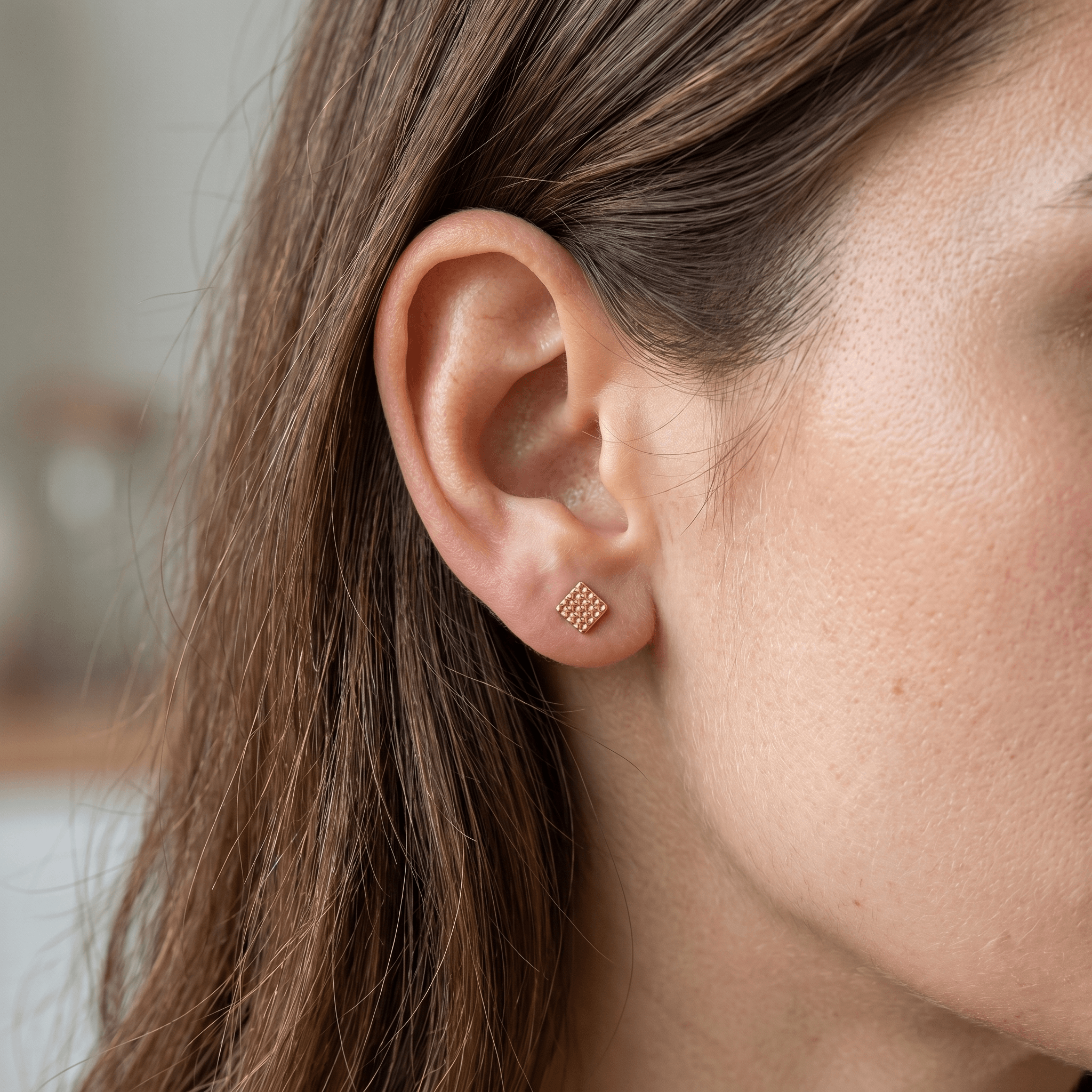 Gold titanium earring worn elegantly in a standard .