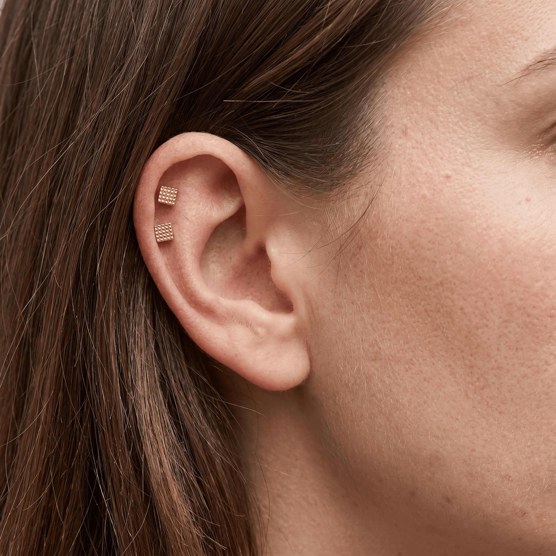 Gold minimalist cartilage jewelry worn in a setup.
