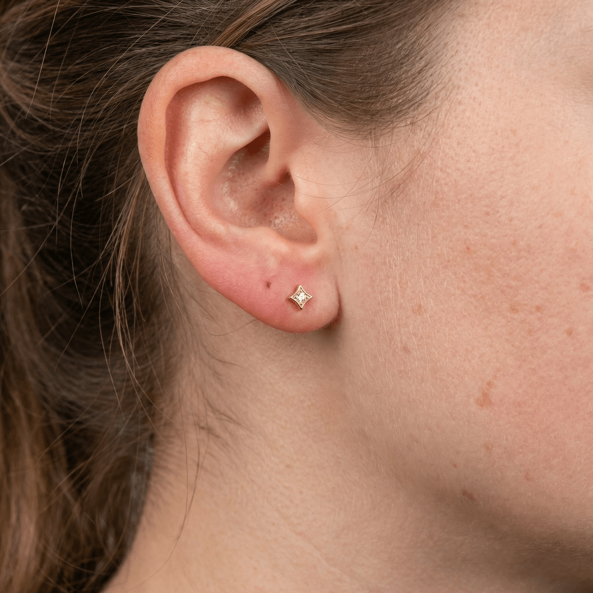 Gold medical-grade titanium piercing worn perfectly in a standard .