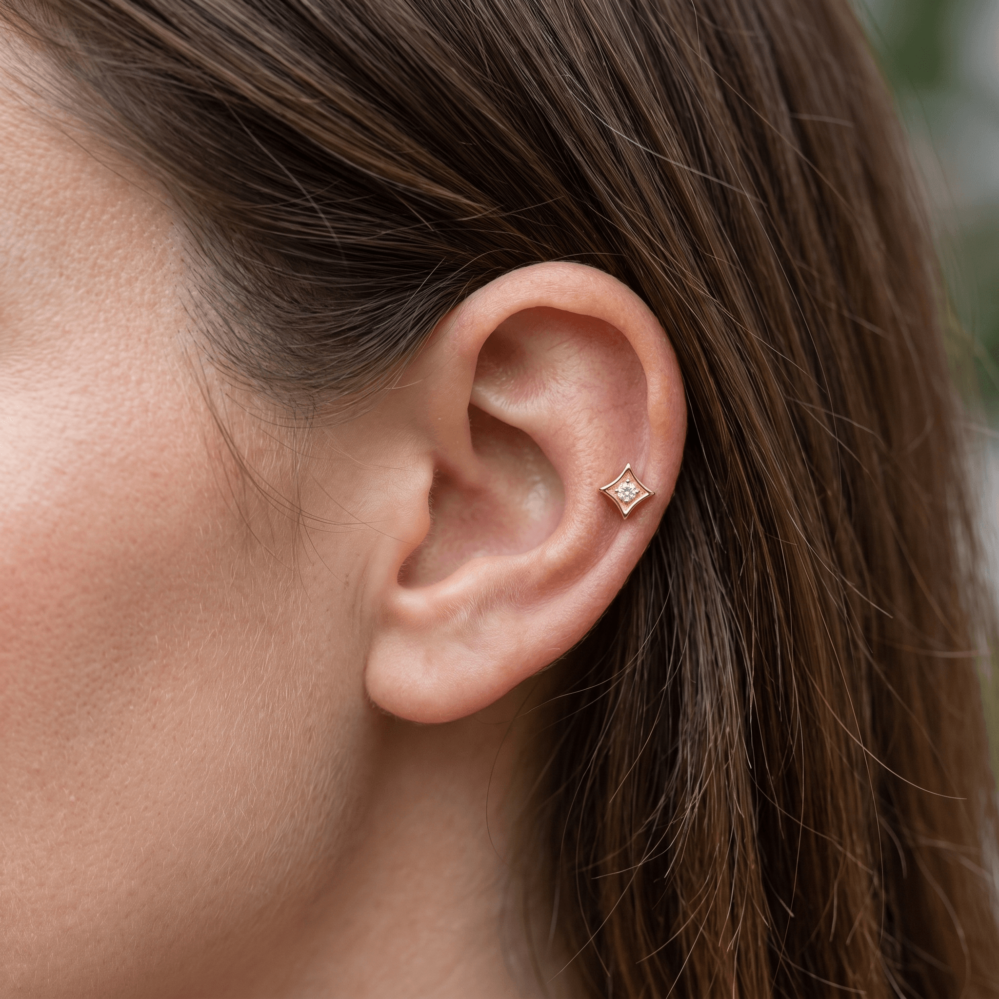 Gold titanium worn elegantly in a piercing.