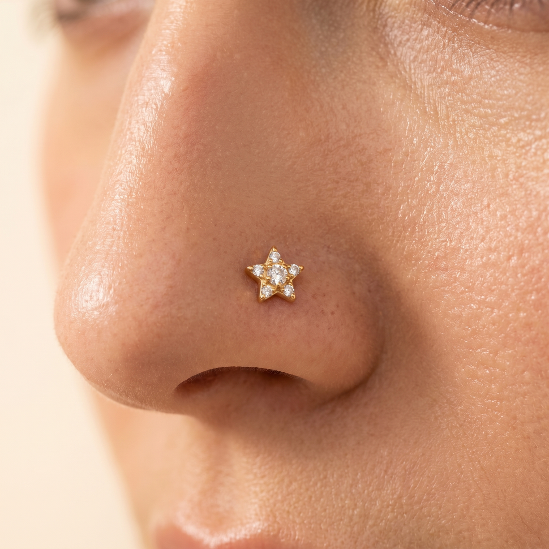 gold star nose stud close-up on a model — single nostril nose jewelry