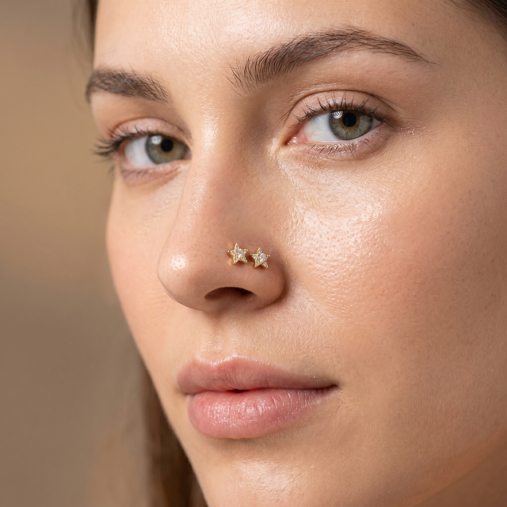 gold star nose stud worn on a model — hypoallergenic titanium