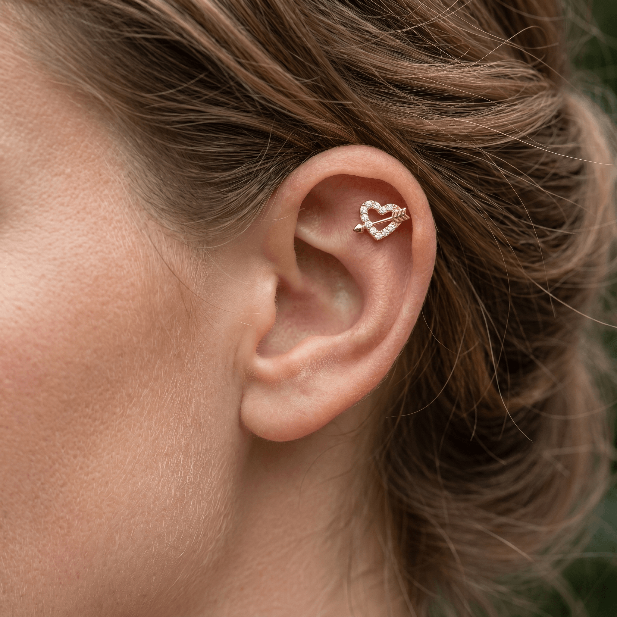 Gold heart arrow zircon stud — flat helix piercing placement
