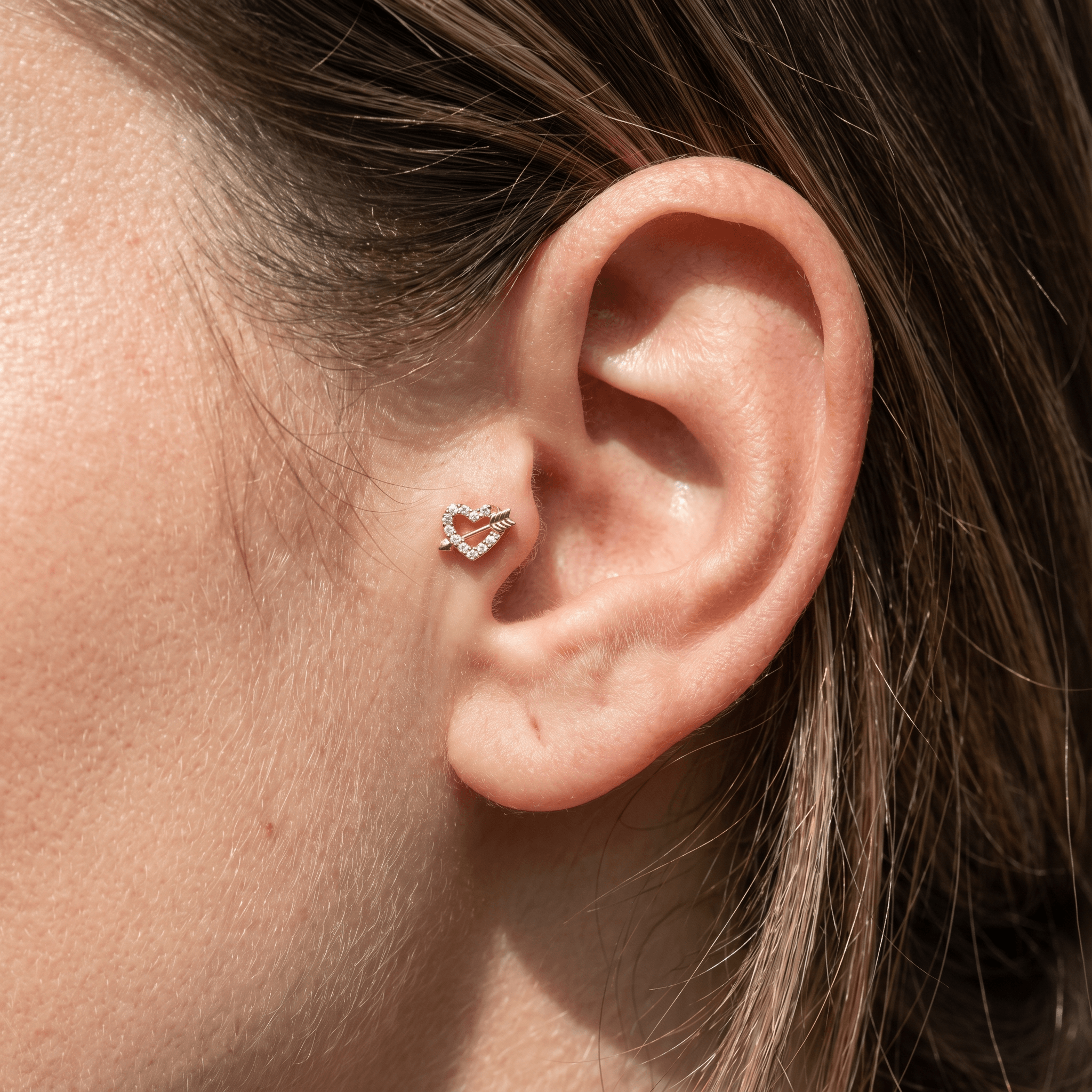 Gold heart arrow zircon stud — tragus jewelry placement