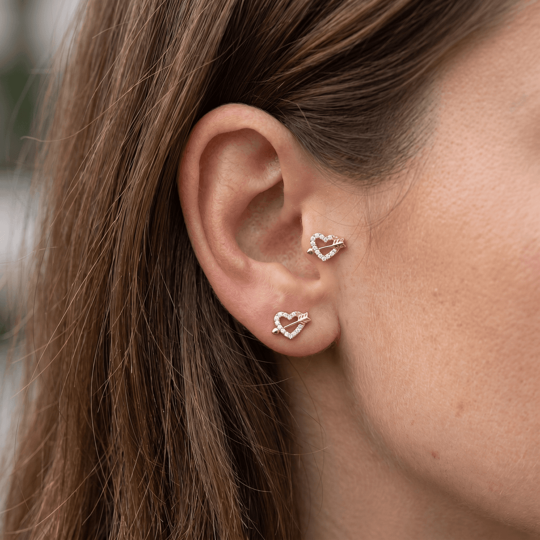 Silver heart arrow zircon stud — tragus antitragus piercing placement