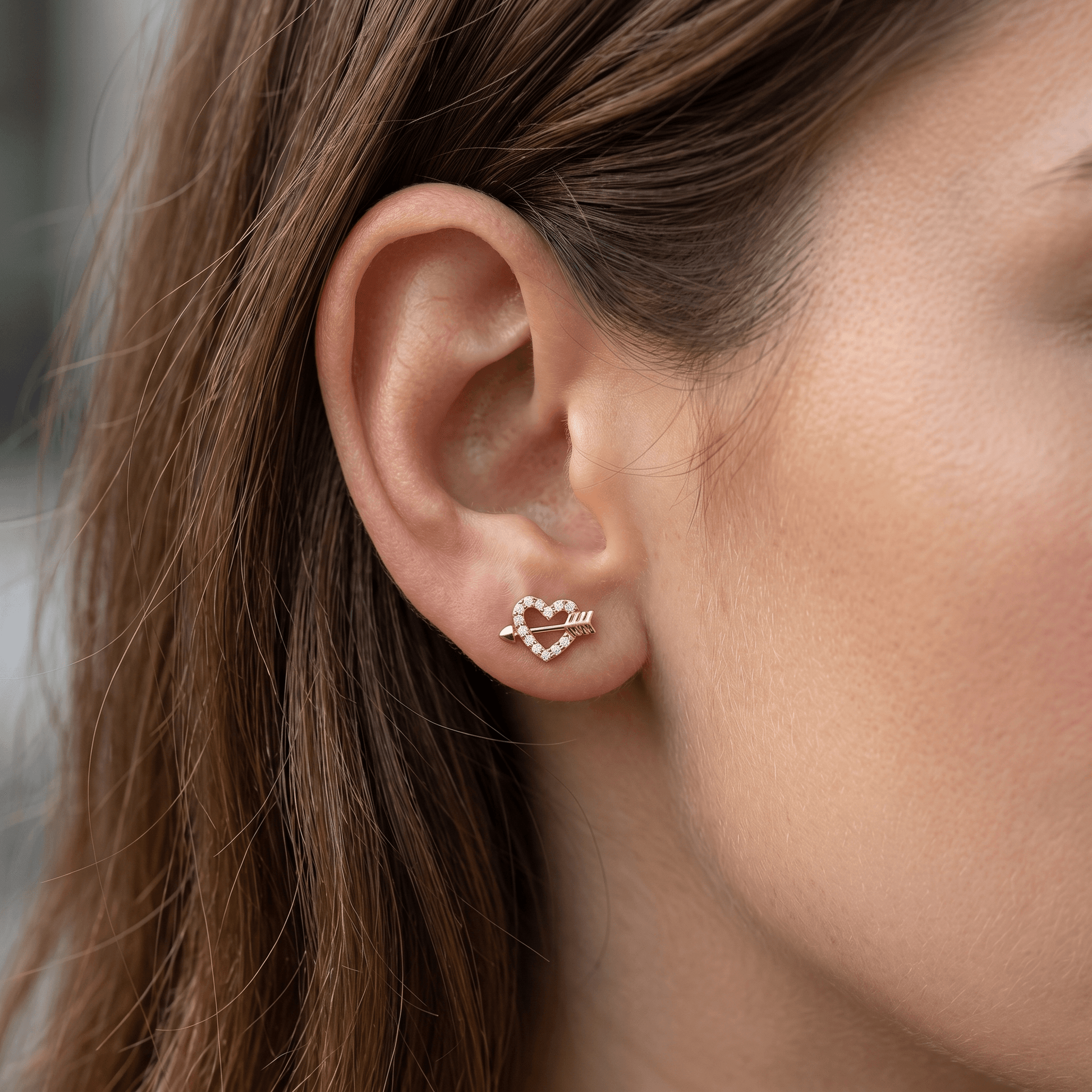 Gold heart arrow zircon stud — anti tragus placement