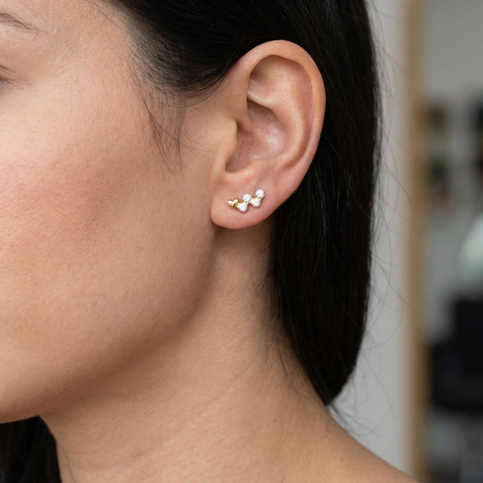 Gold heart cz cluster stud worn gracefully in a standard placement.