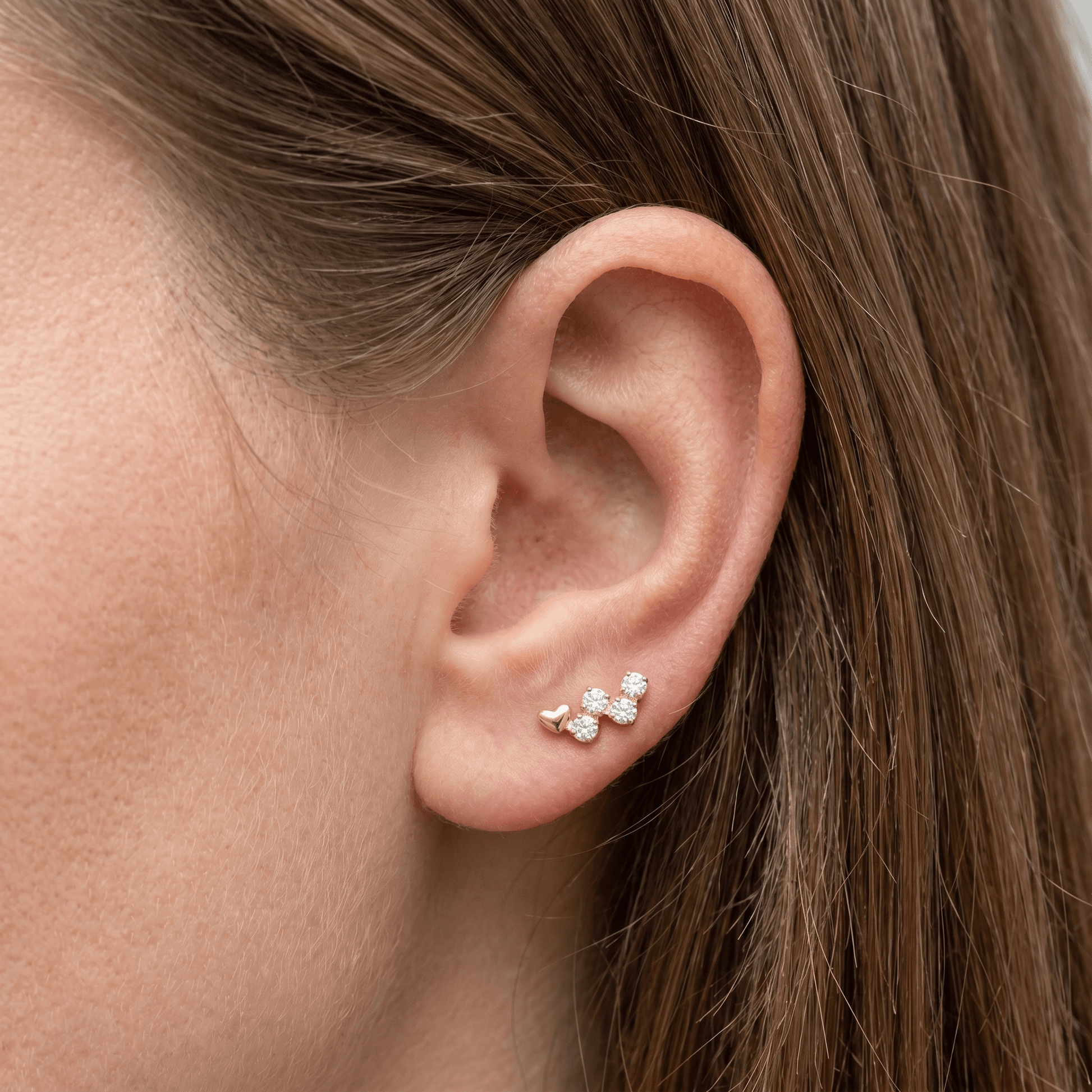 Gold heart cz cluster jewelry styled beautifully along the piercing.