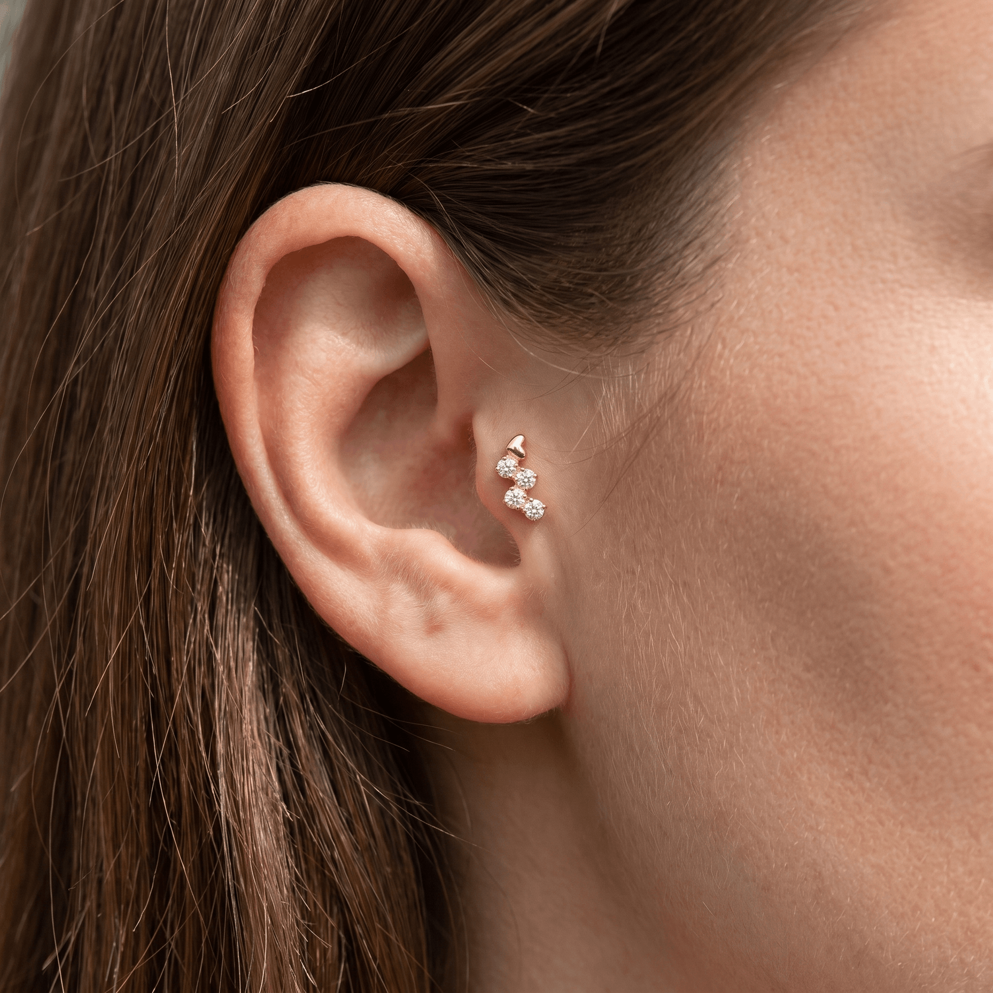 Gold heart clear stone cluster stud worn elegantly in a ear piercing.
