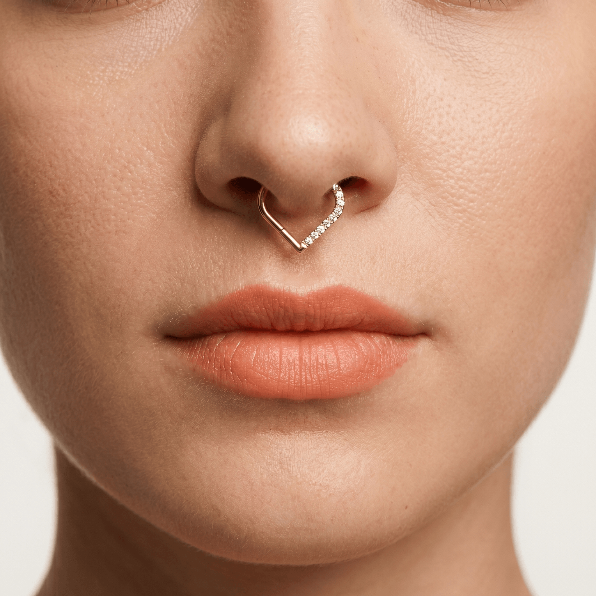 Gold heart shaped piercing jewelry with clear zircon stones worn elegantly in