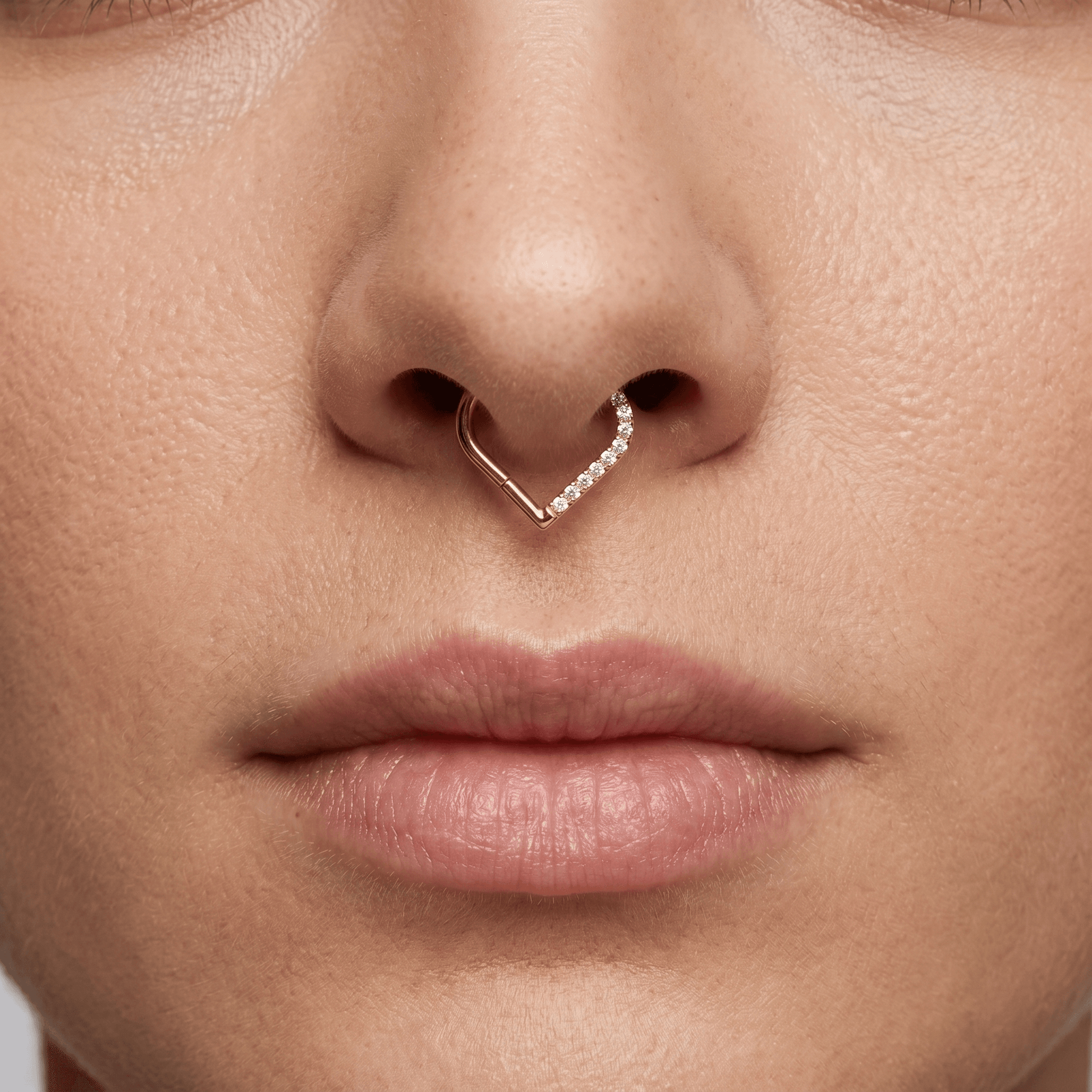 Gold heart shaped zircon stud — small septum placement