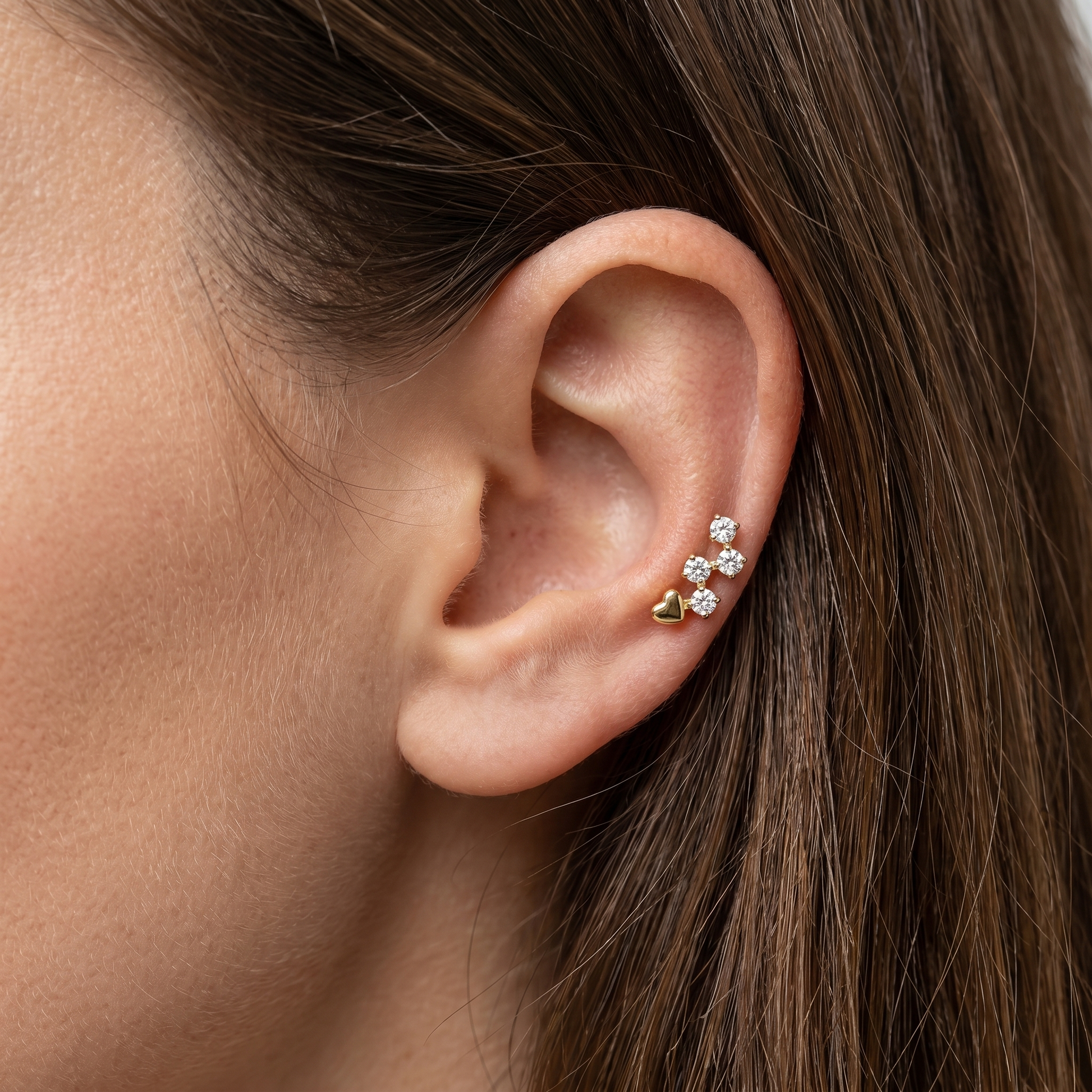 Gold heart & zircon stud — mid helix piercing placement
