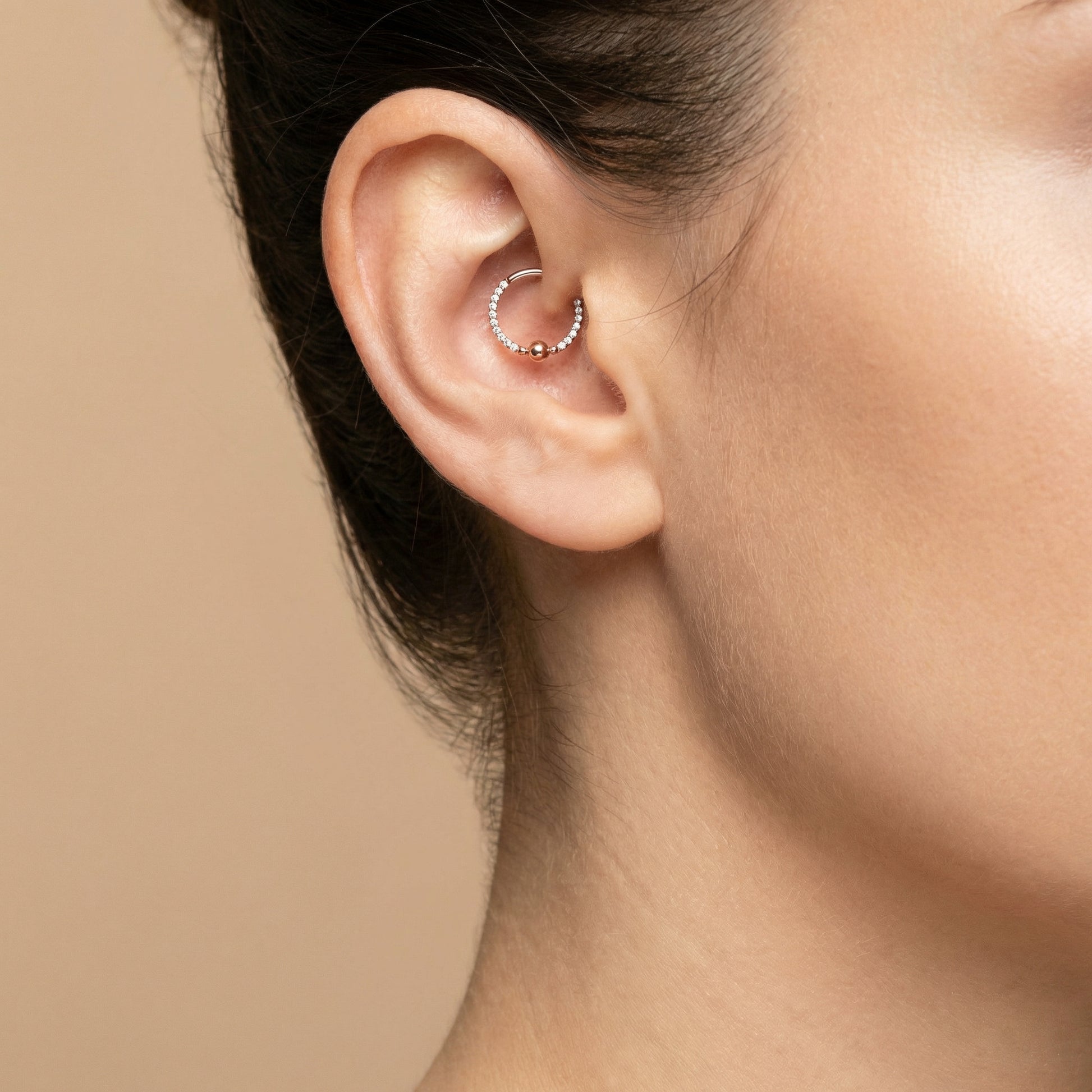 Silver zircon center bead clicker hoop worn neatly inside the ear piercing.