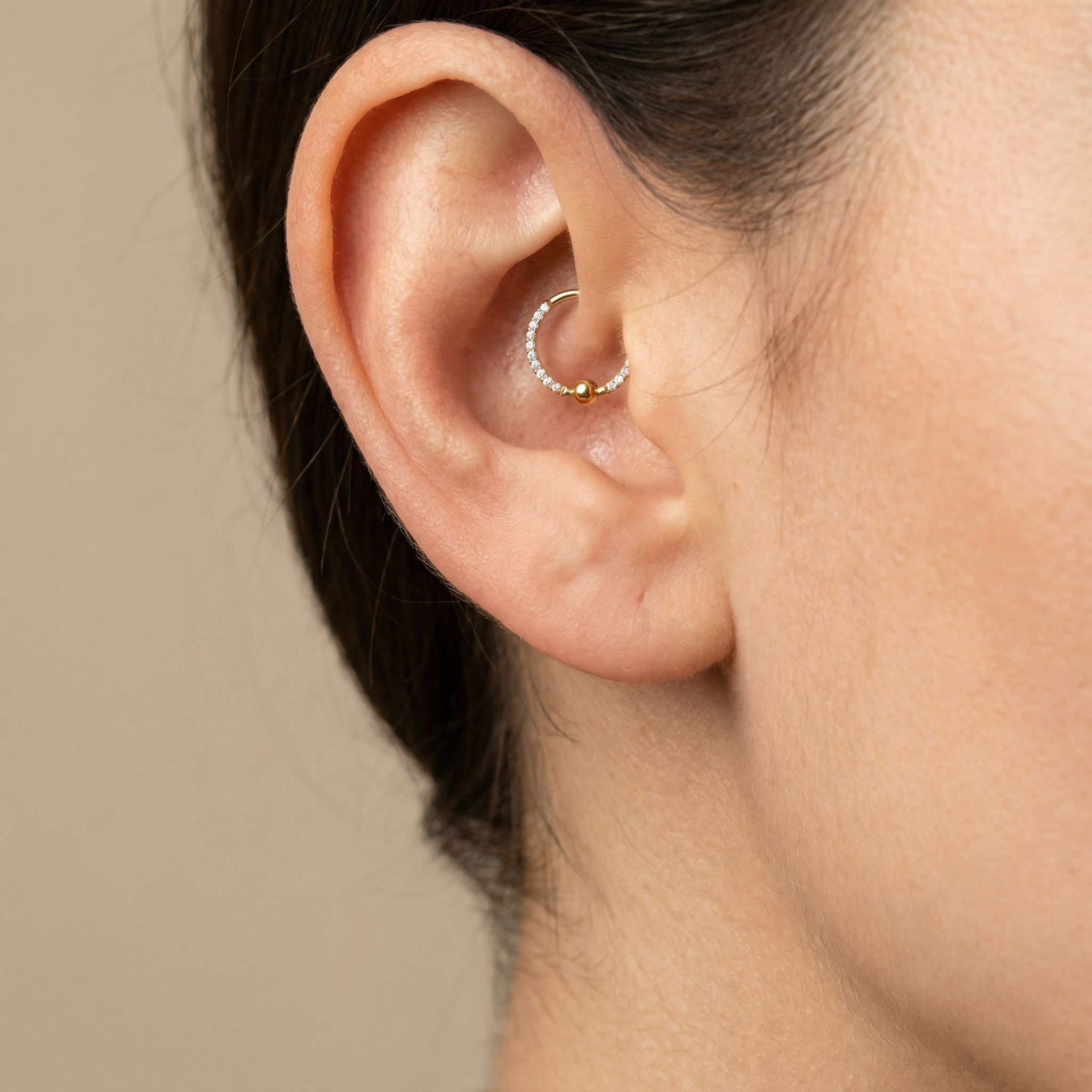Macro profile shot of a silver zircon center bead clicker hoop inside