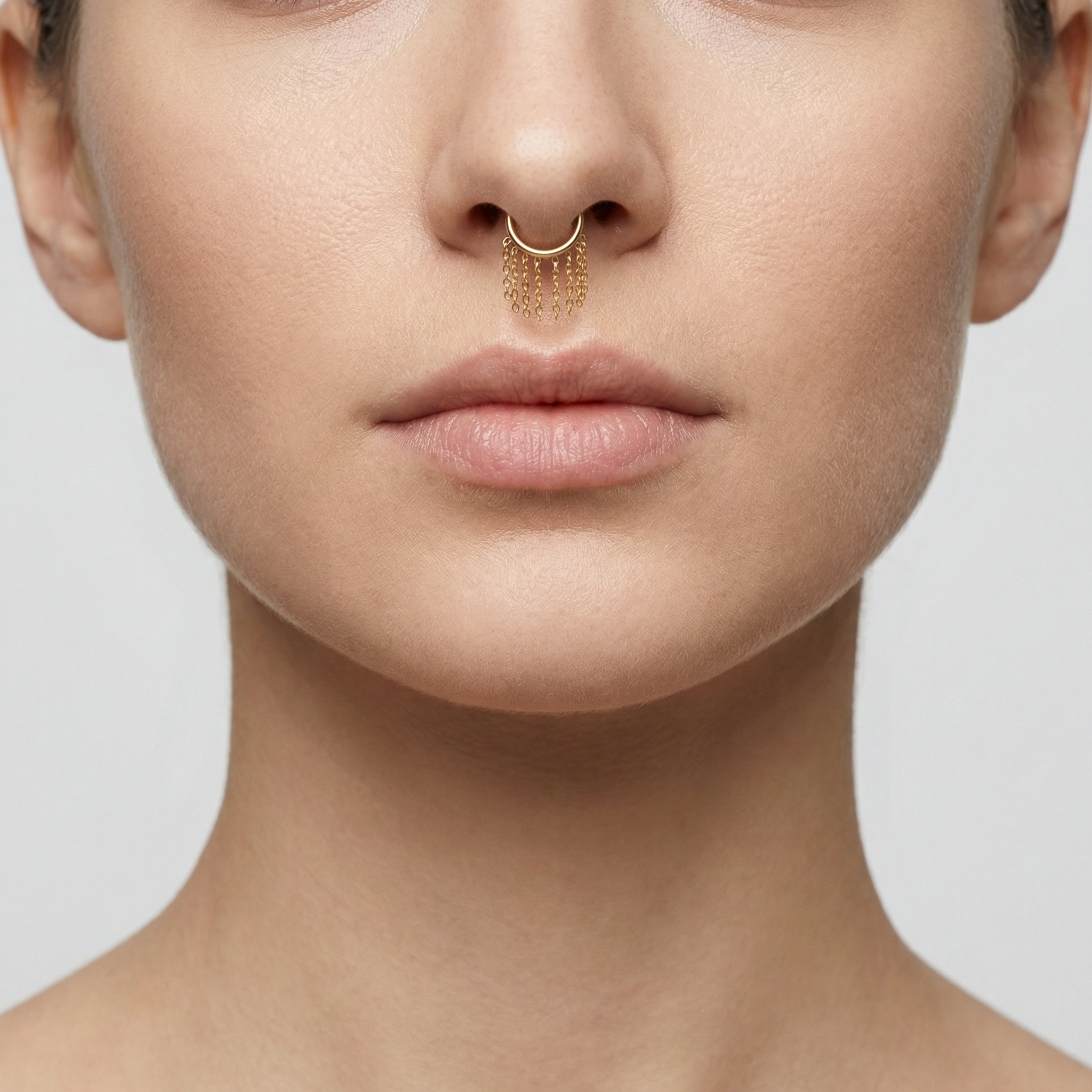 Model close-up facing front showing the gold cascading dangling chain clicker ring