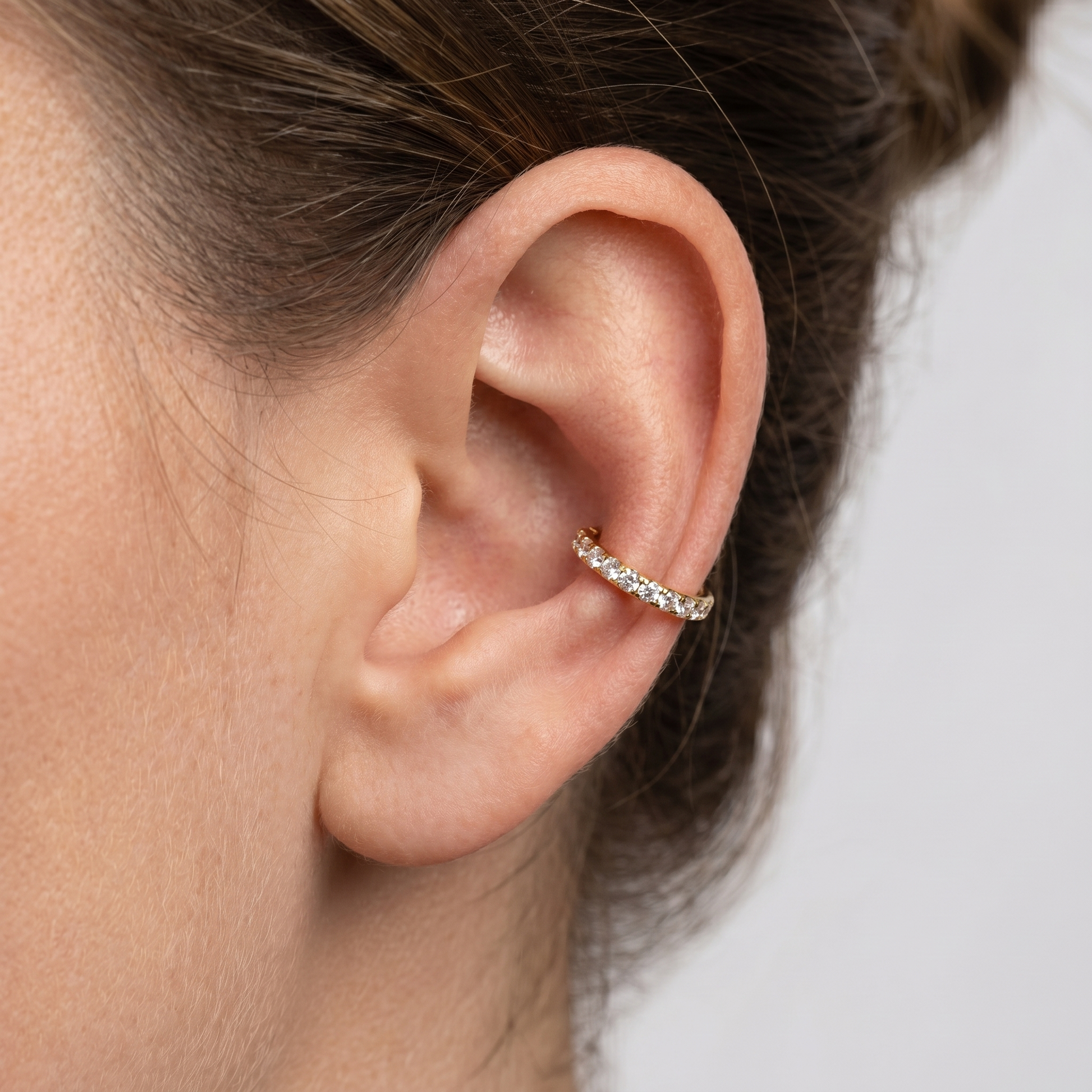 Gold zircon paved hinged stud — outer conch piercing placement