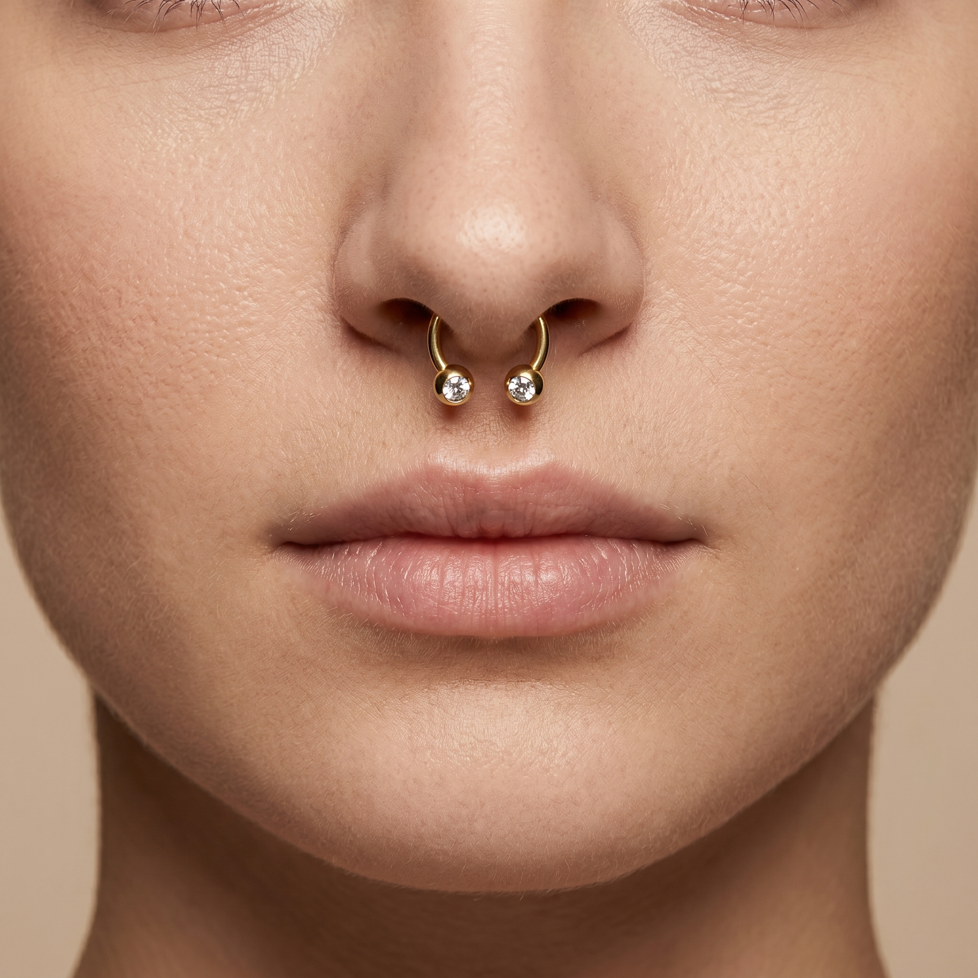 Gold titanium crystal ball horseshoe ring worn perfectly in a female piercing.