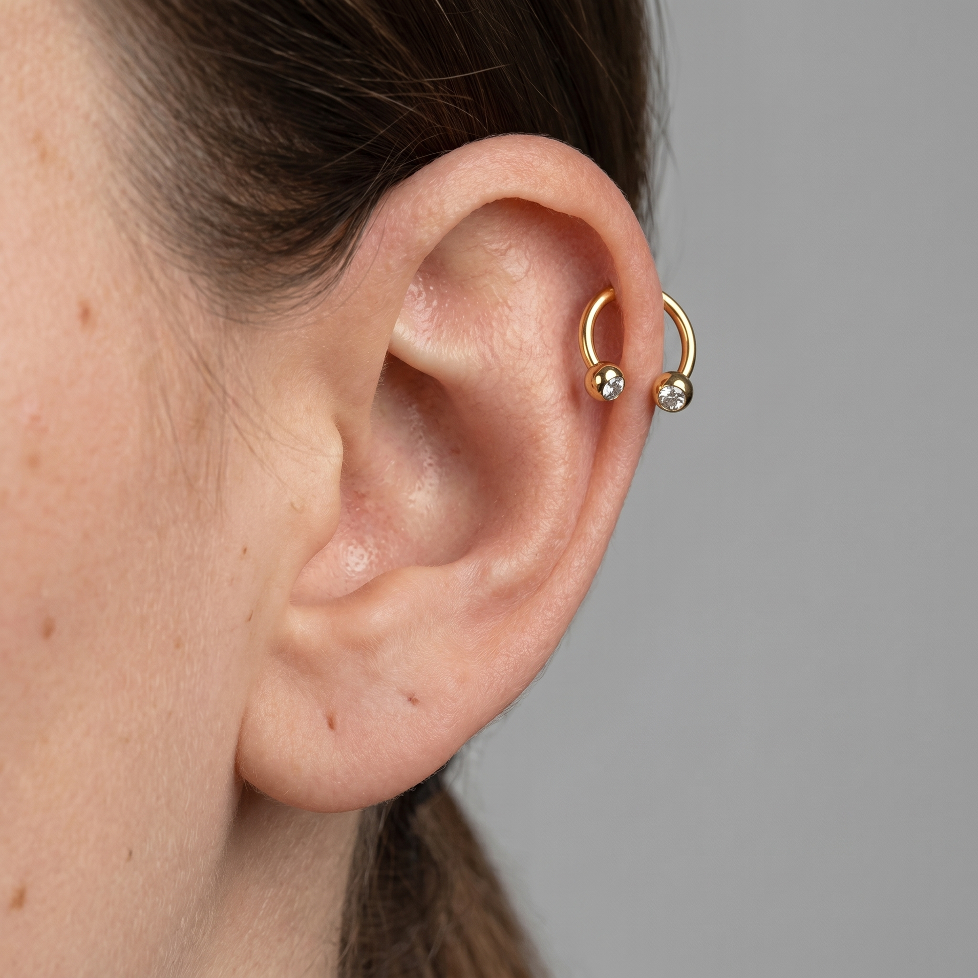 Gold crystal ball horseshoe stud — helix jewelry placement
