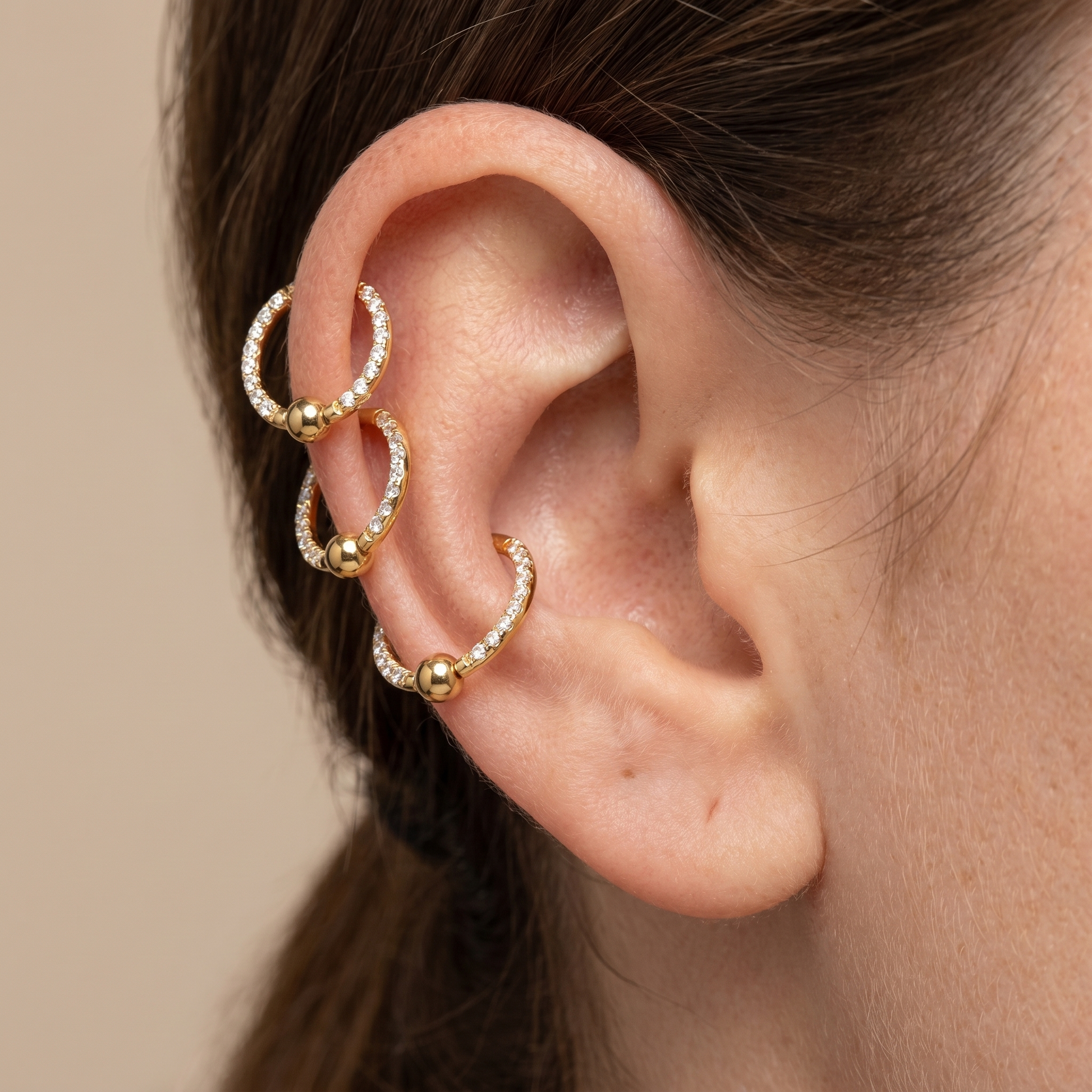 Gold zircon center bead stud — triple helix piercing placement