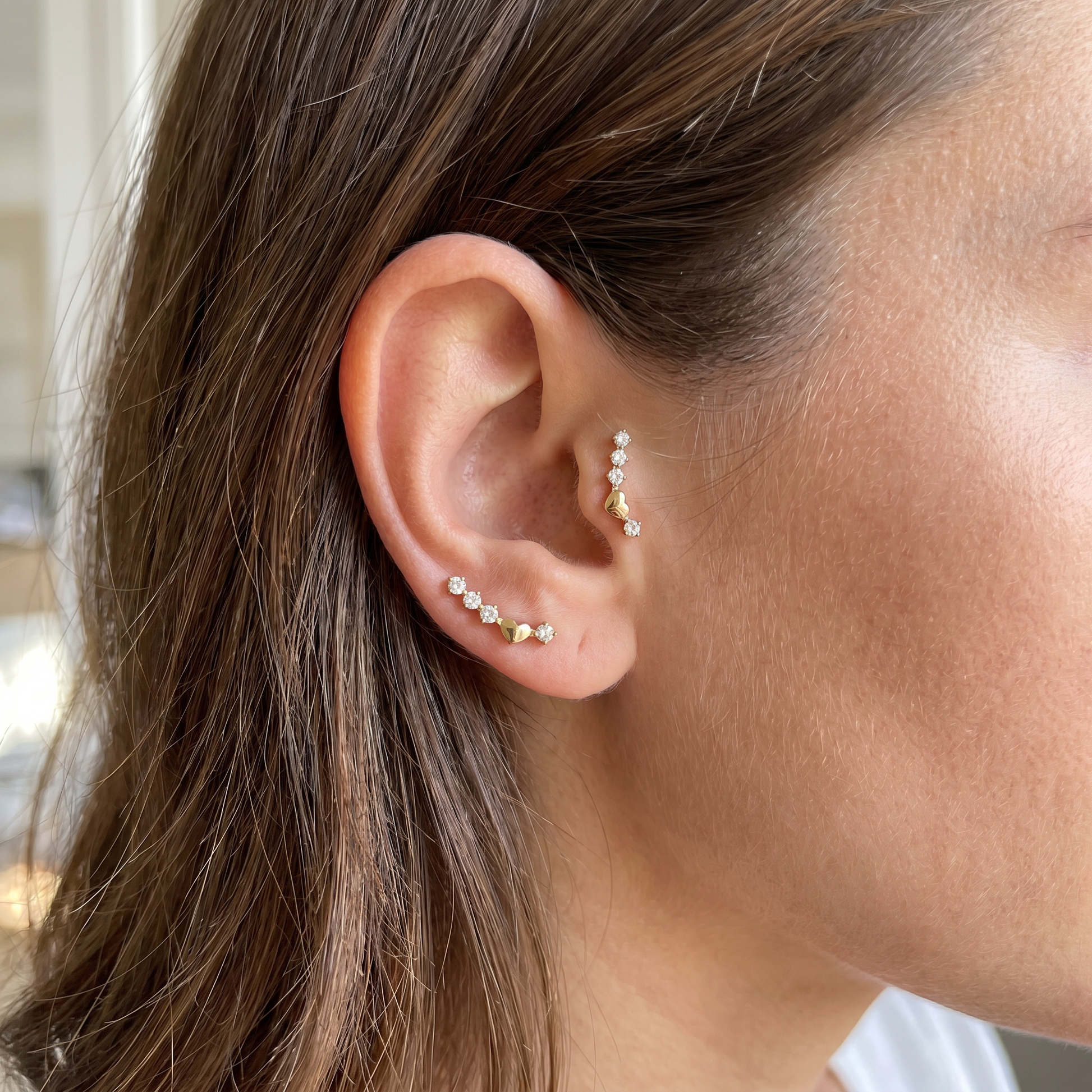 Gold curved zircon stud — tragus antitragus piercing placement