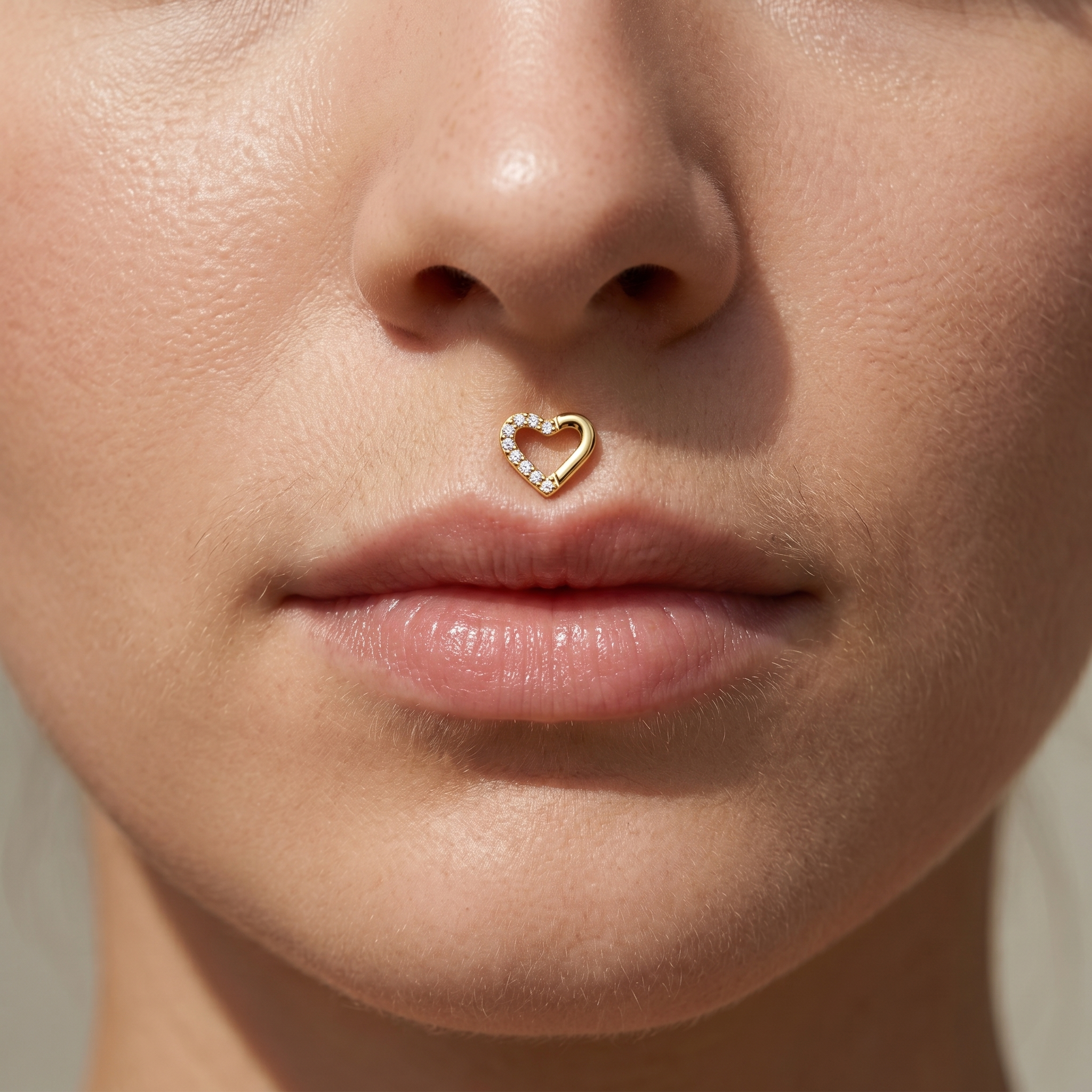 Gold open heart zircon stud — medusa piercing placement