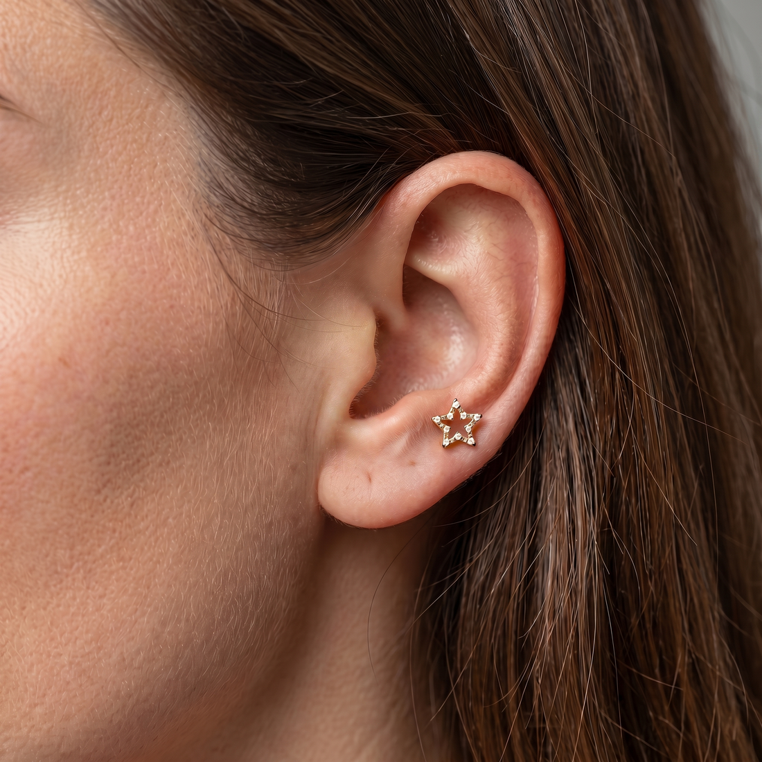 Gold open star zircon stud — anti tragus placement