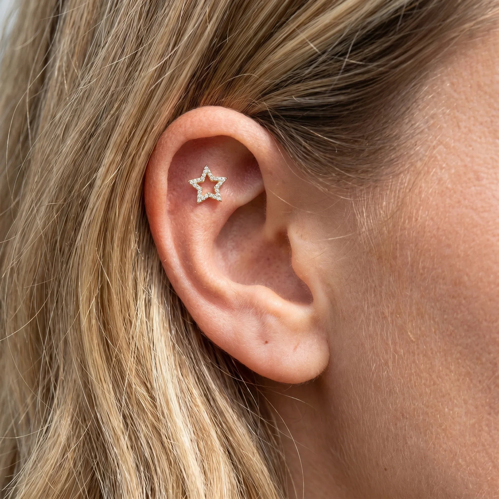 Silver open star piercing stud worn beautifully in a placement.