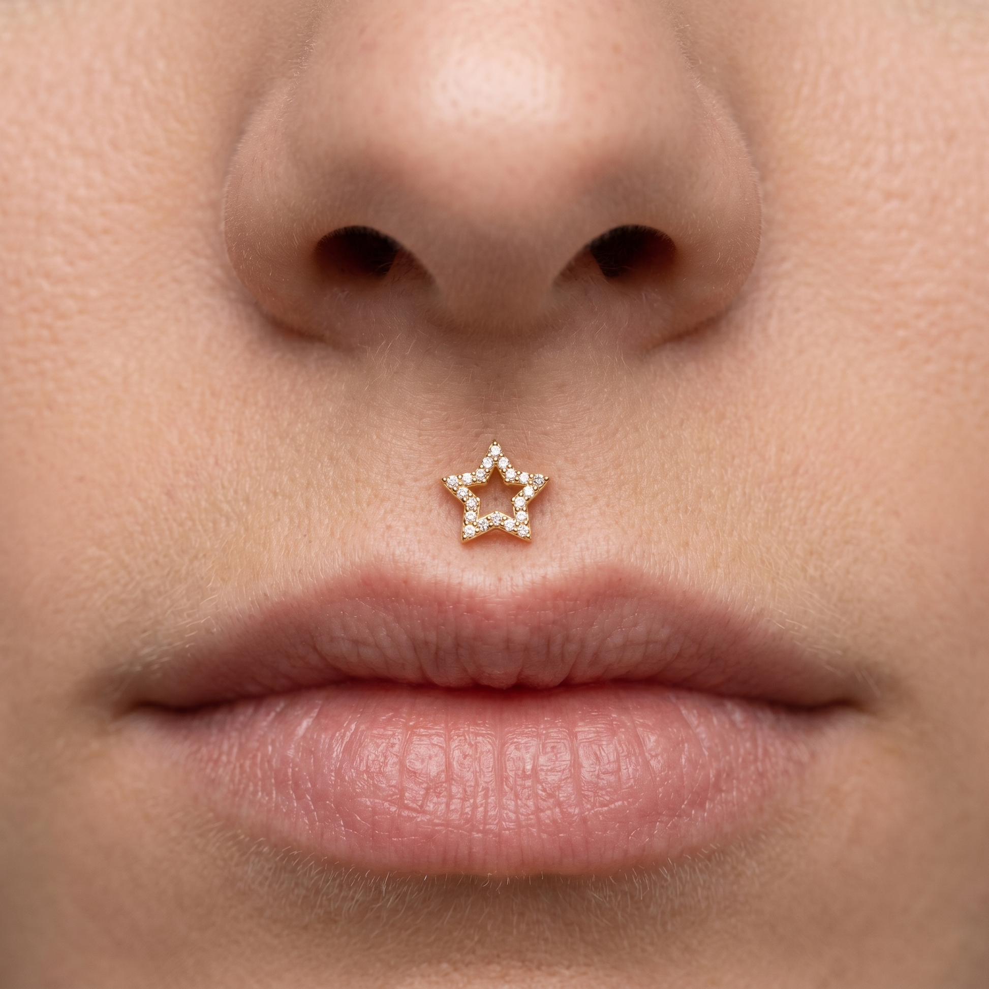 Gold open star piercing stud worn perfectly in a piercing.