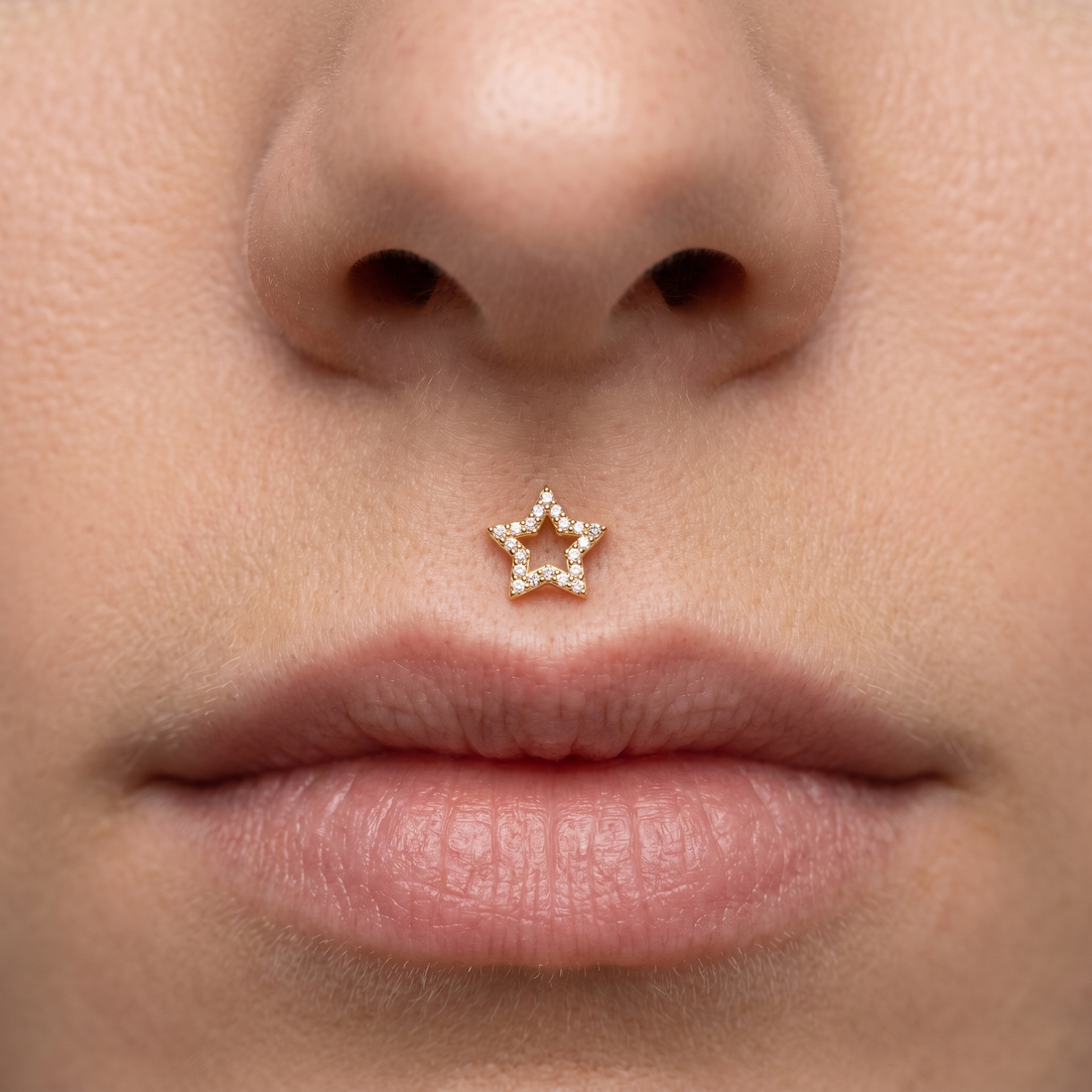 Gold open star zircon stud — medusa piercing placement