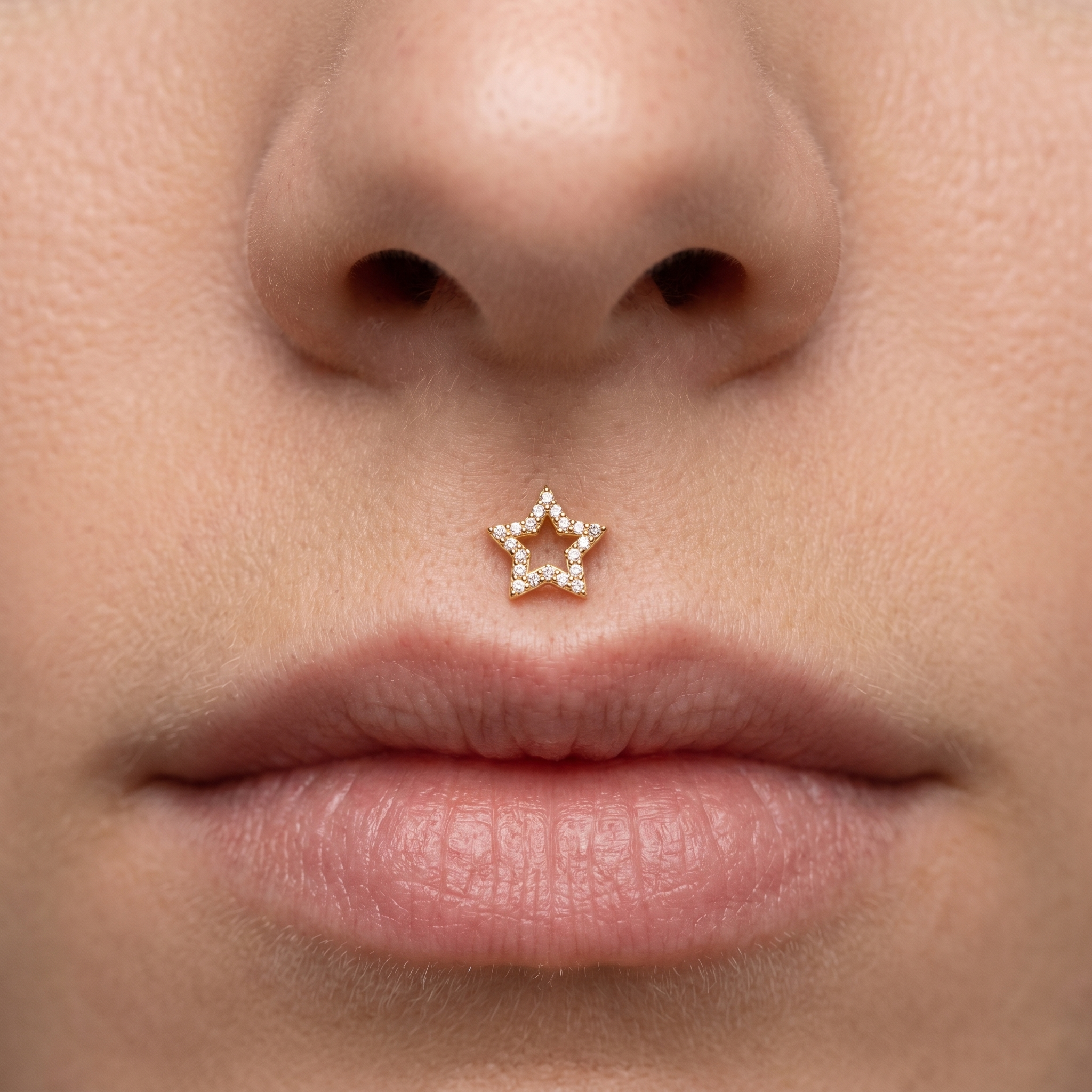 Gold open star zircon stud — medusa piercing placement