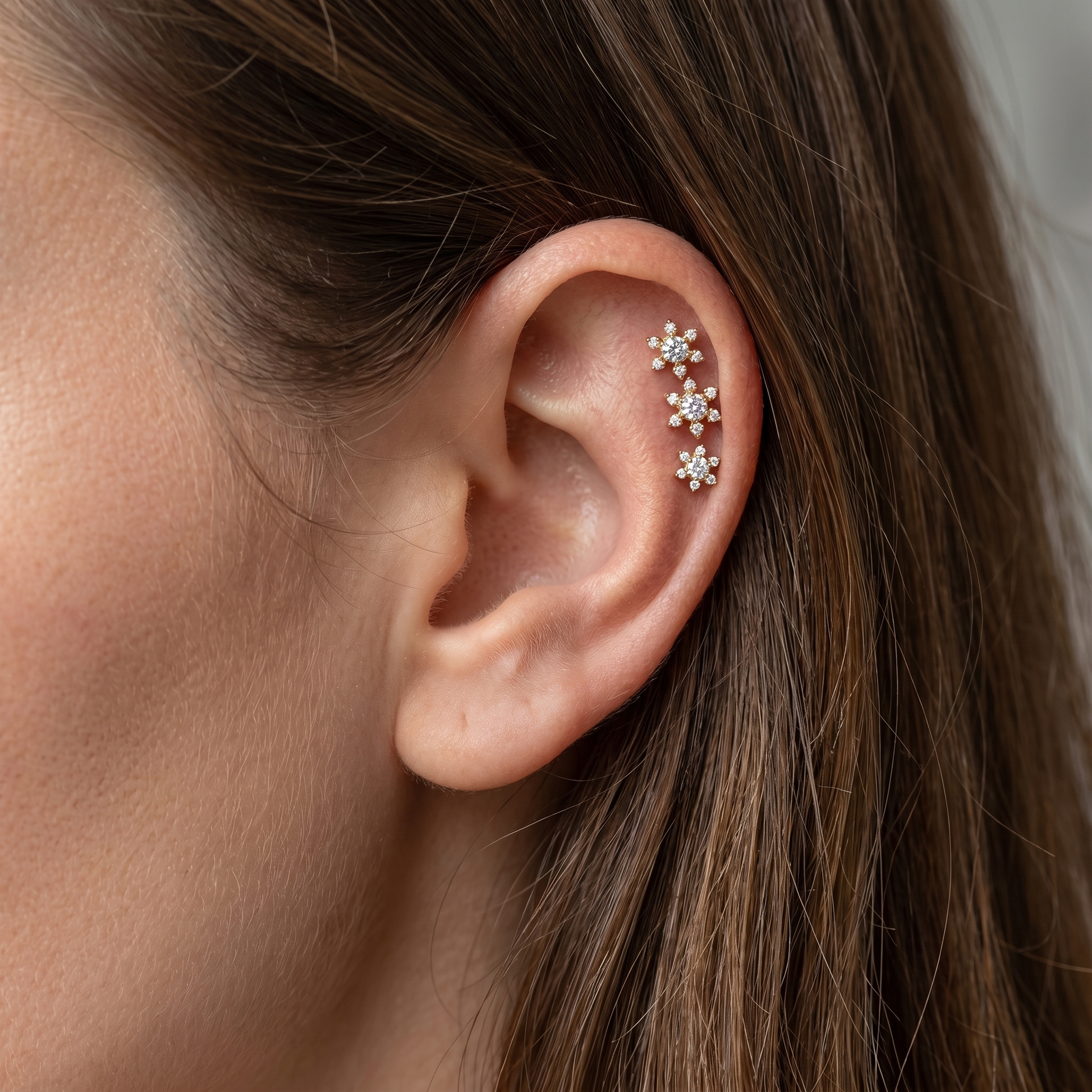 Gold flower zircon stud — triple helix piercing placement