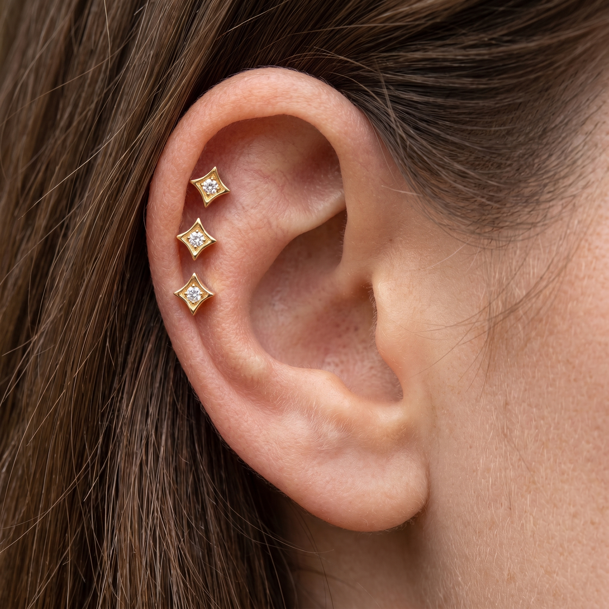 Gold geometric zircon stud — triple helix piercing placement