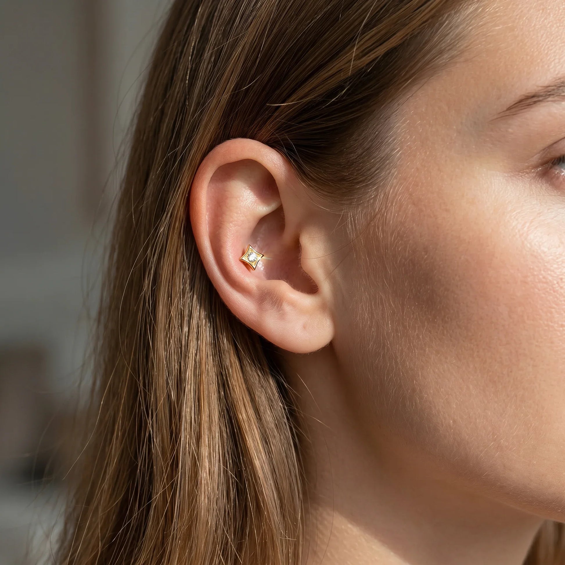 Gold hypoallergenic lip ring styled as a piercing.