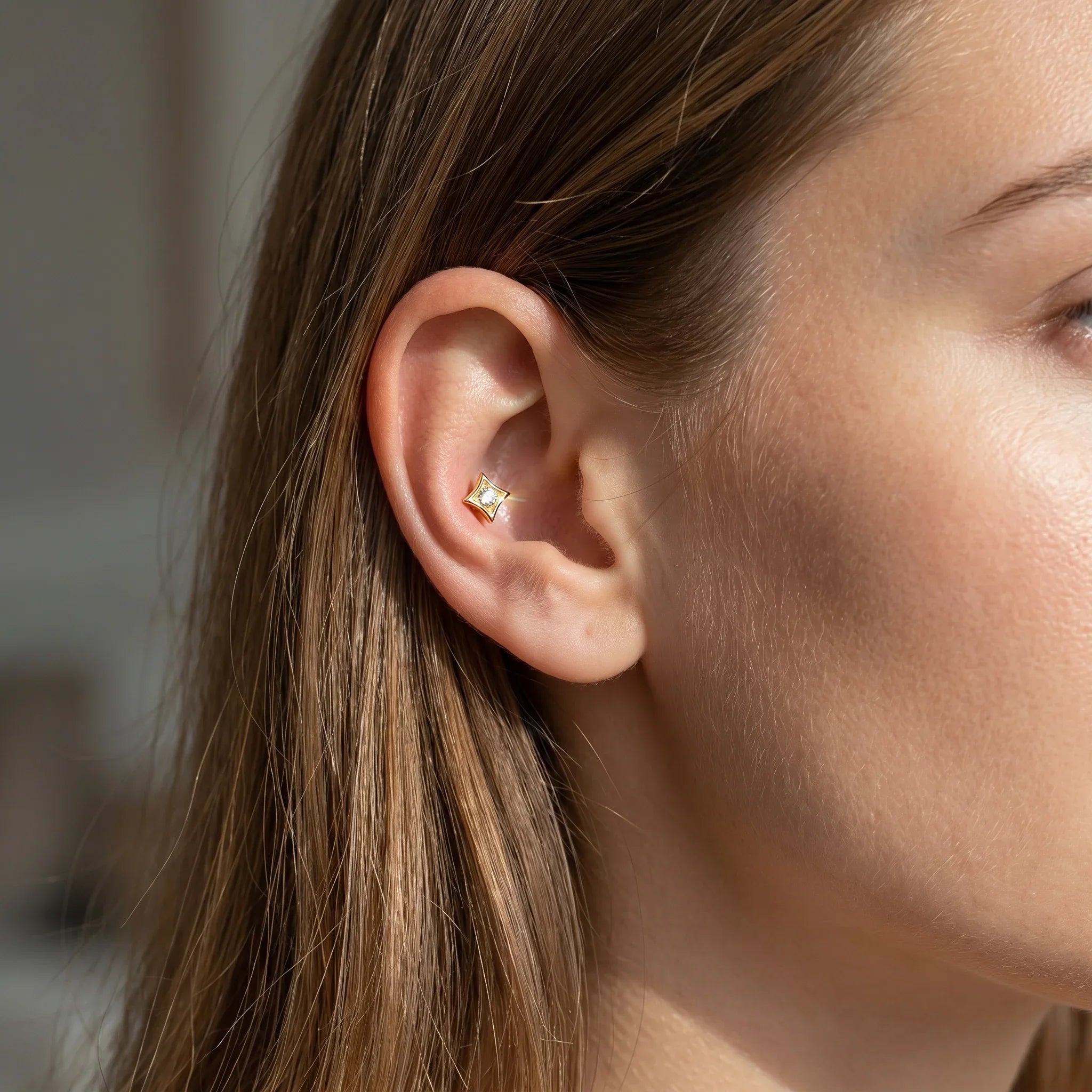 Gold hypoallergenic lip ring styled as a piercing.