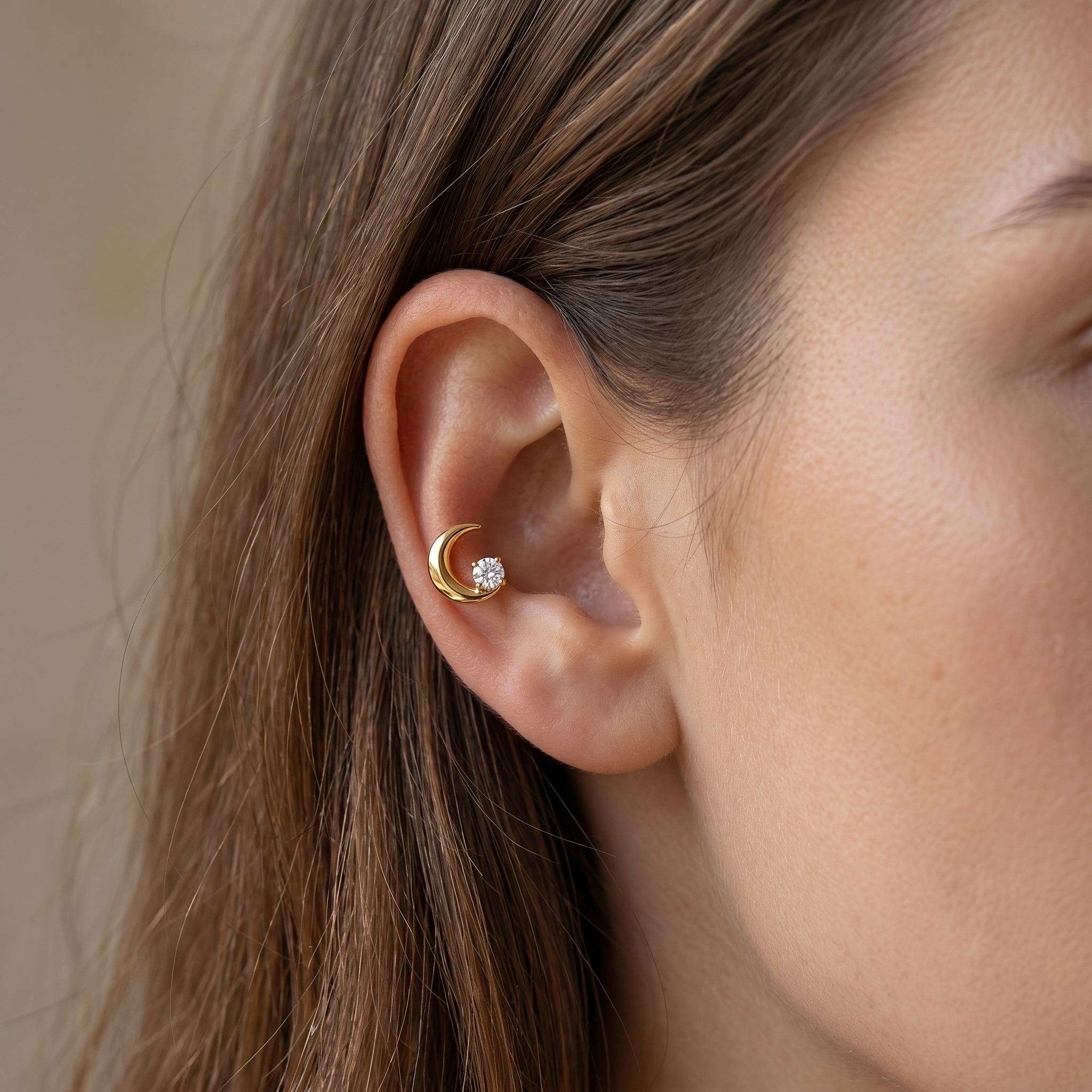 Gold crescent moon zircon stud — mid helix piercing placement