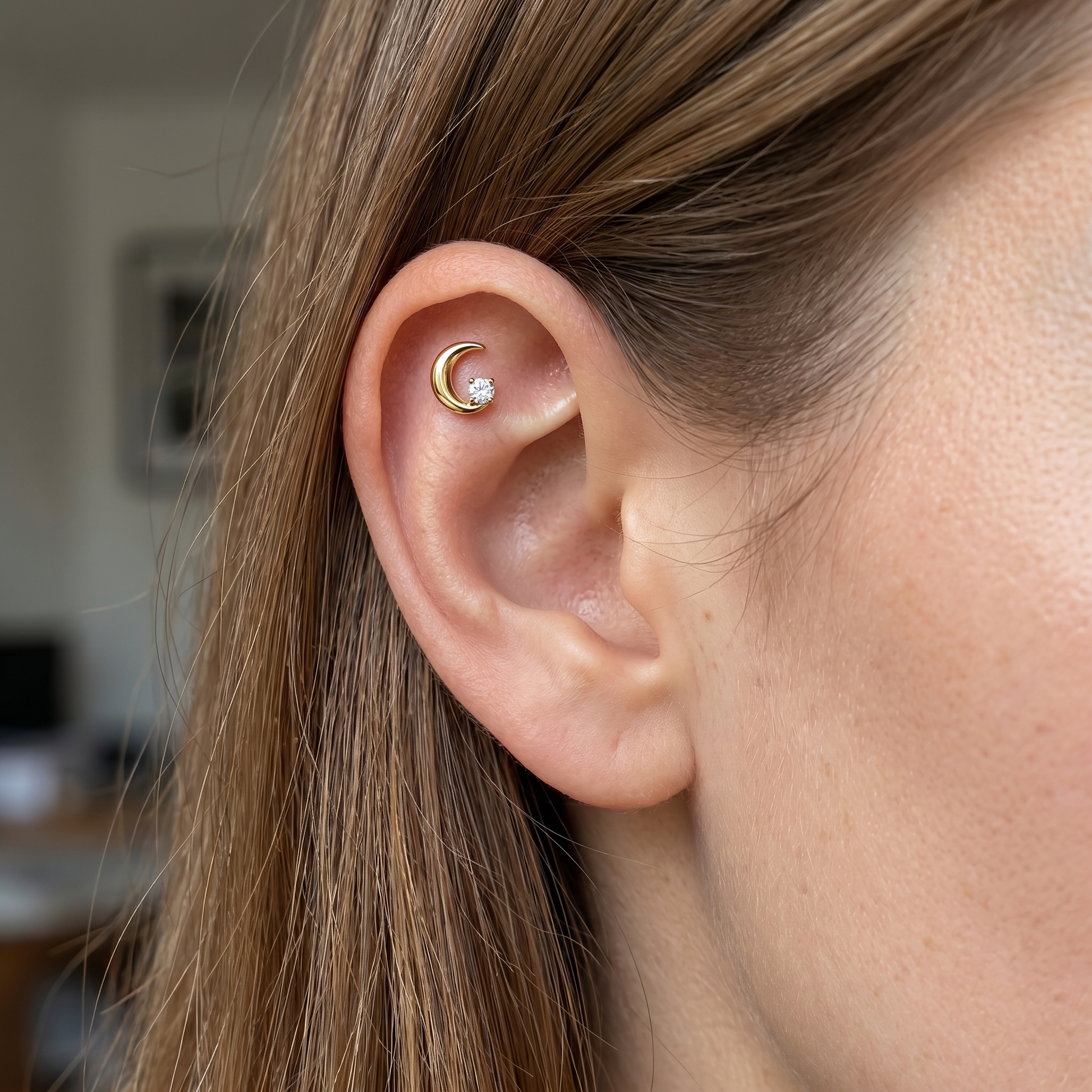 Gold crescent moon zircon stud — flat helix piercing placement