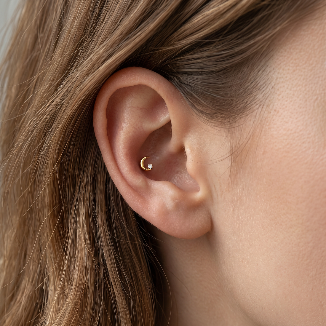 Silver crescent moon zircon stud — conch ear placement
