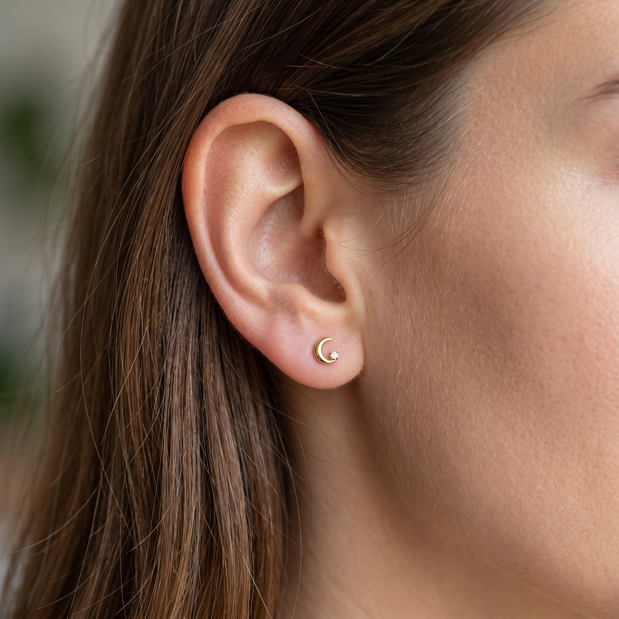 Gold hypoallergenic ear stack jewelry styled in a high piercing.