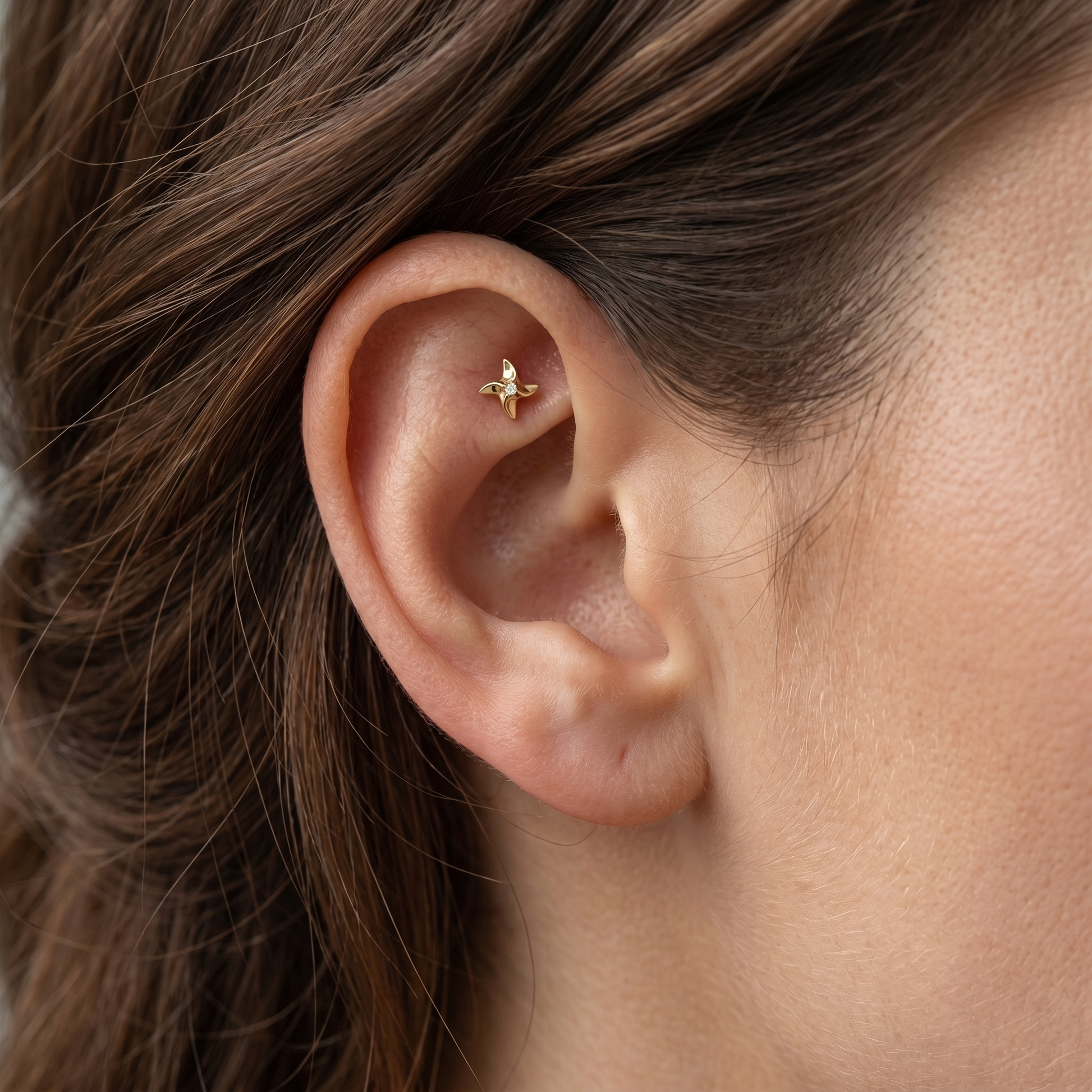 Gold pinwheel zircon stud — faux rook piercing placement