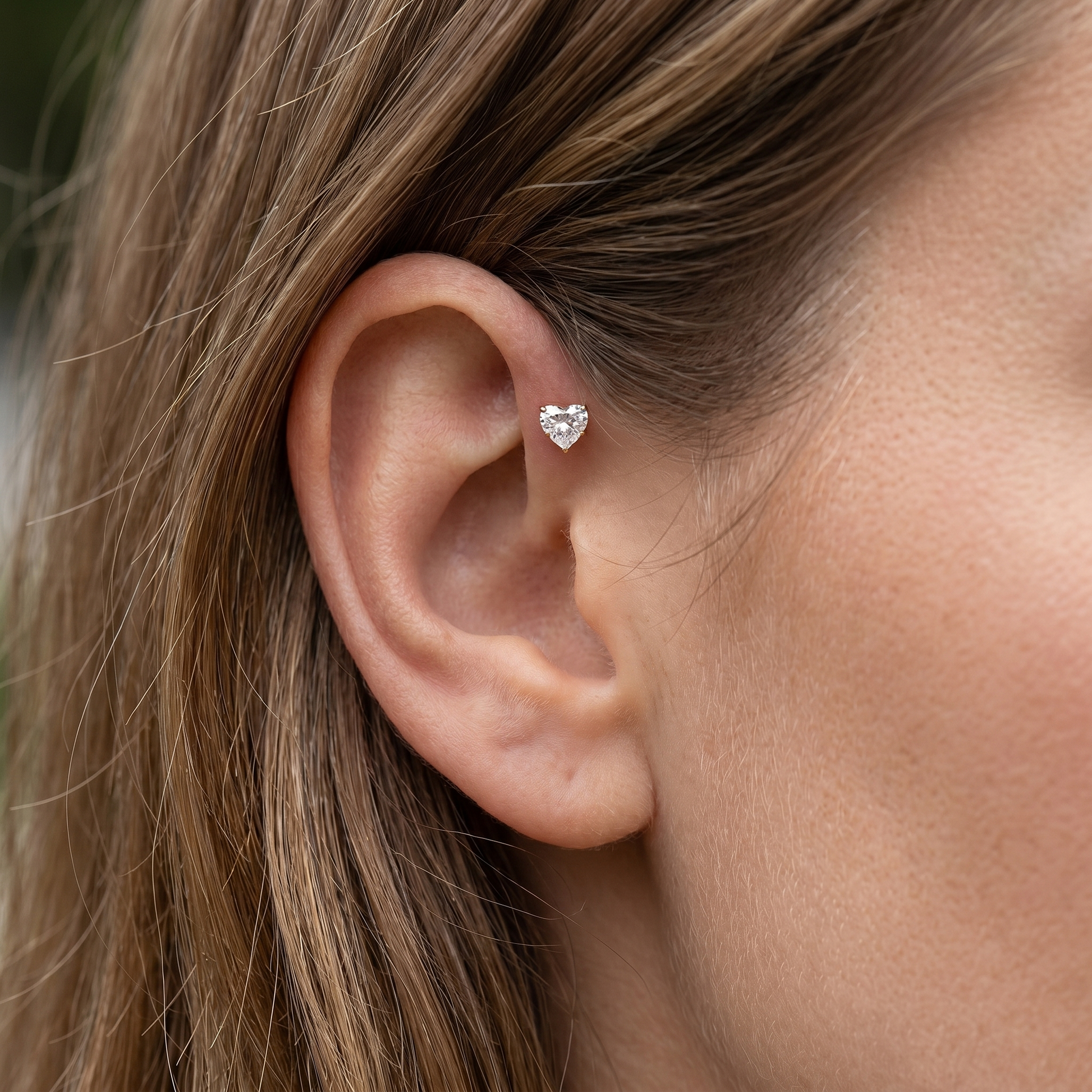 Gold heart zircon stud — forward helix piercing placement