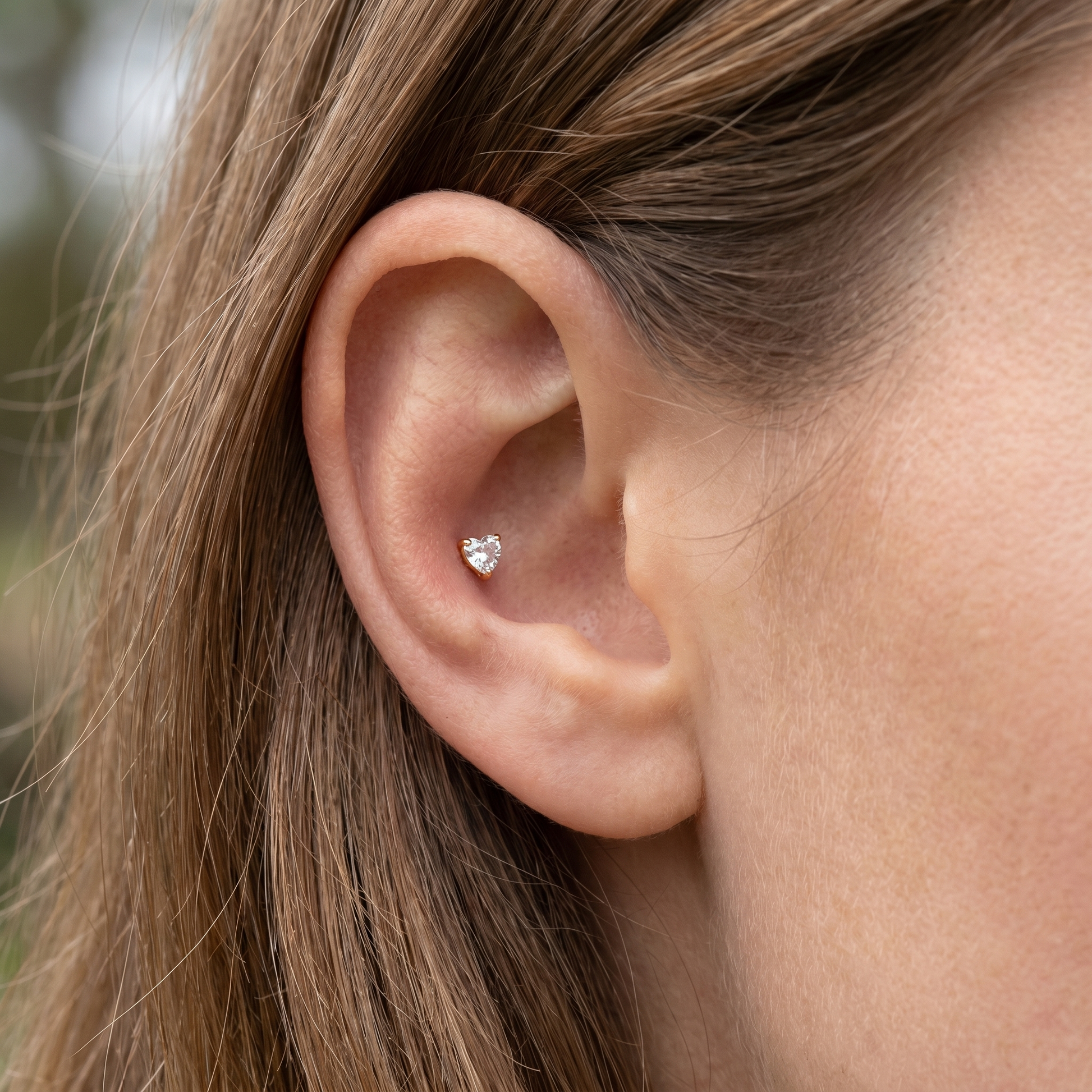 Gold heart zircon stud — outer conch piercing placement