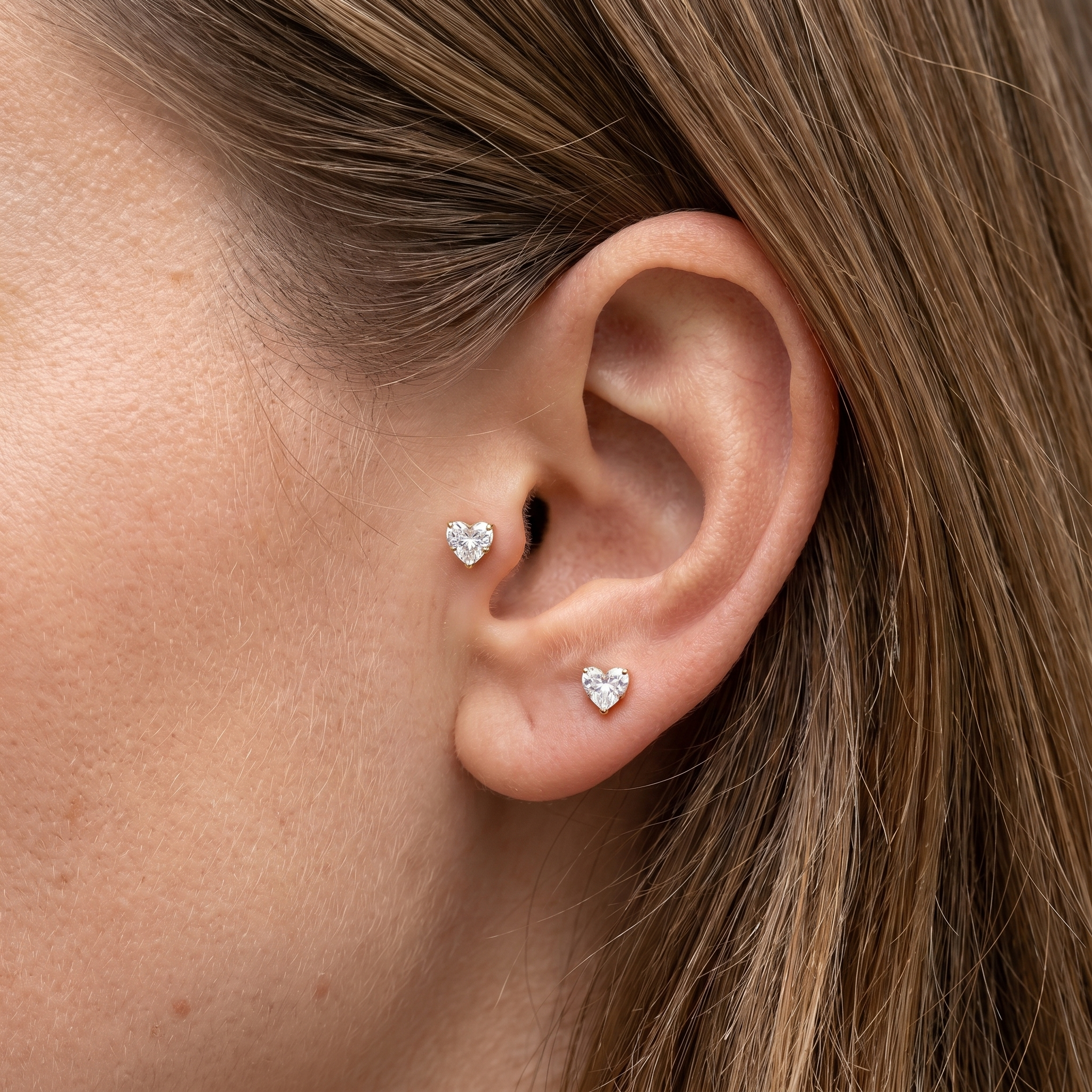 Gold heart zircon stud — tragus antitragus piercing placement